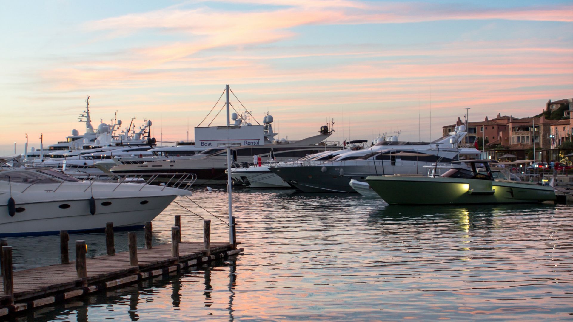 Image shows yacht on a port in Porto Cervo, Sardinia, Italy. 