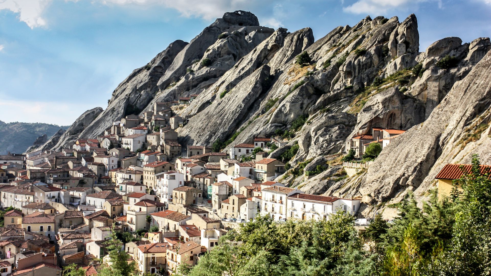 Image shows Potenza, Basilicata, Italy characterized by its unique landscape, nestled within the Lucanian Dolomites, and its architecture is integrated with the surrounding rock formations.