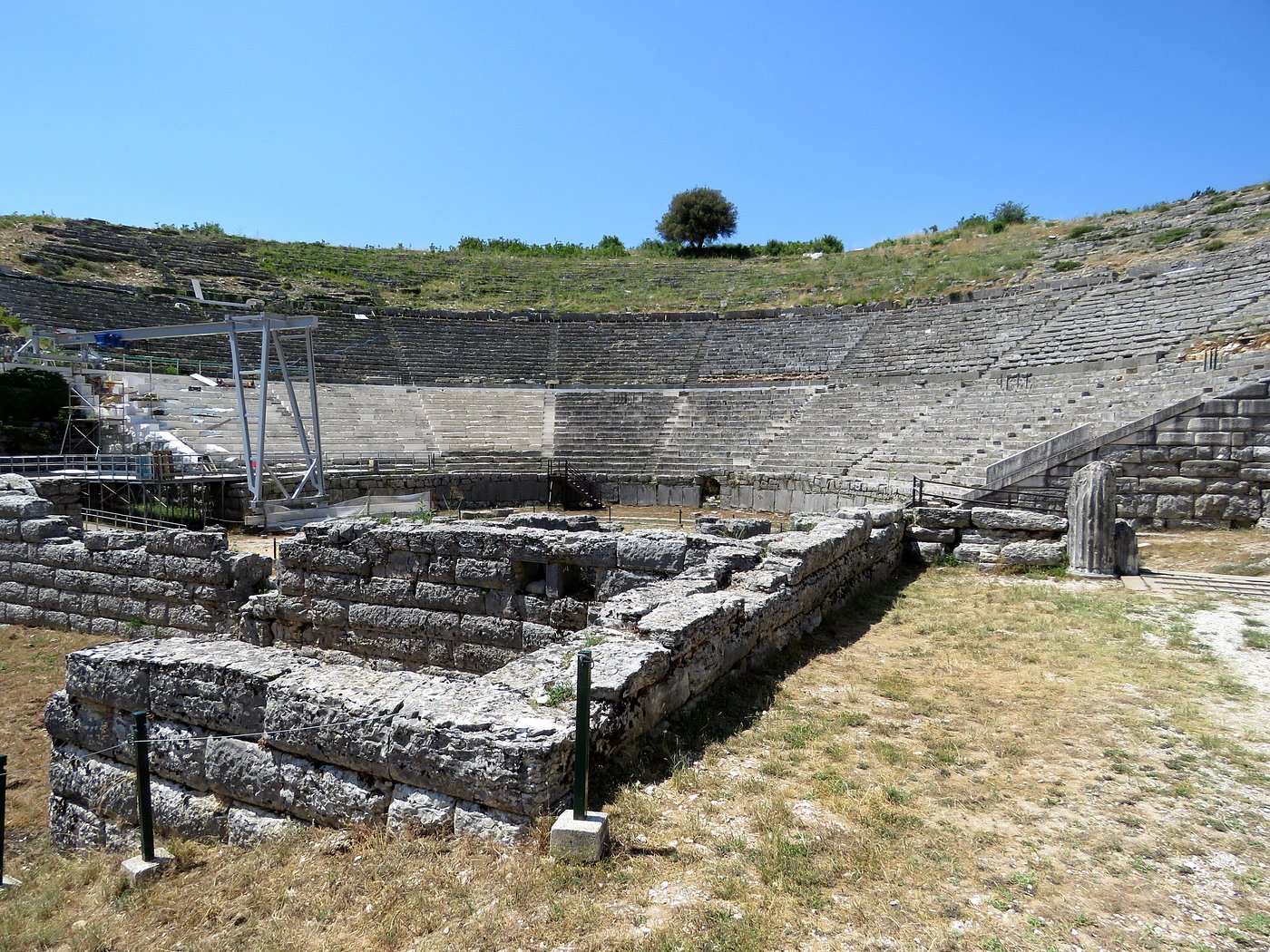 The Grand Theatre of Dodona, with ancient stone seats and a scenic backdrop.