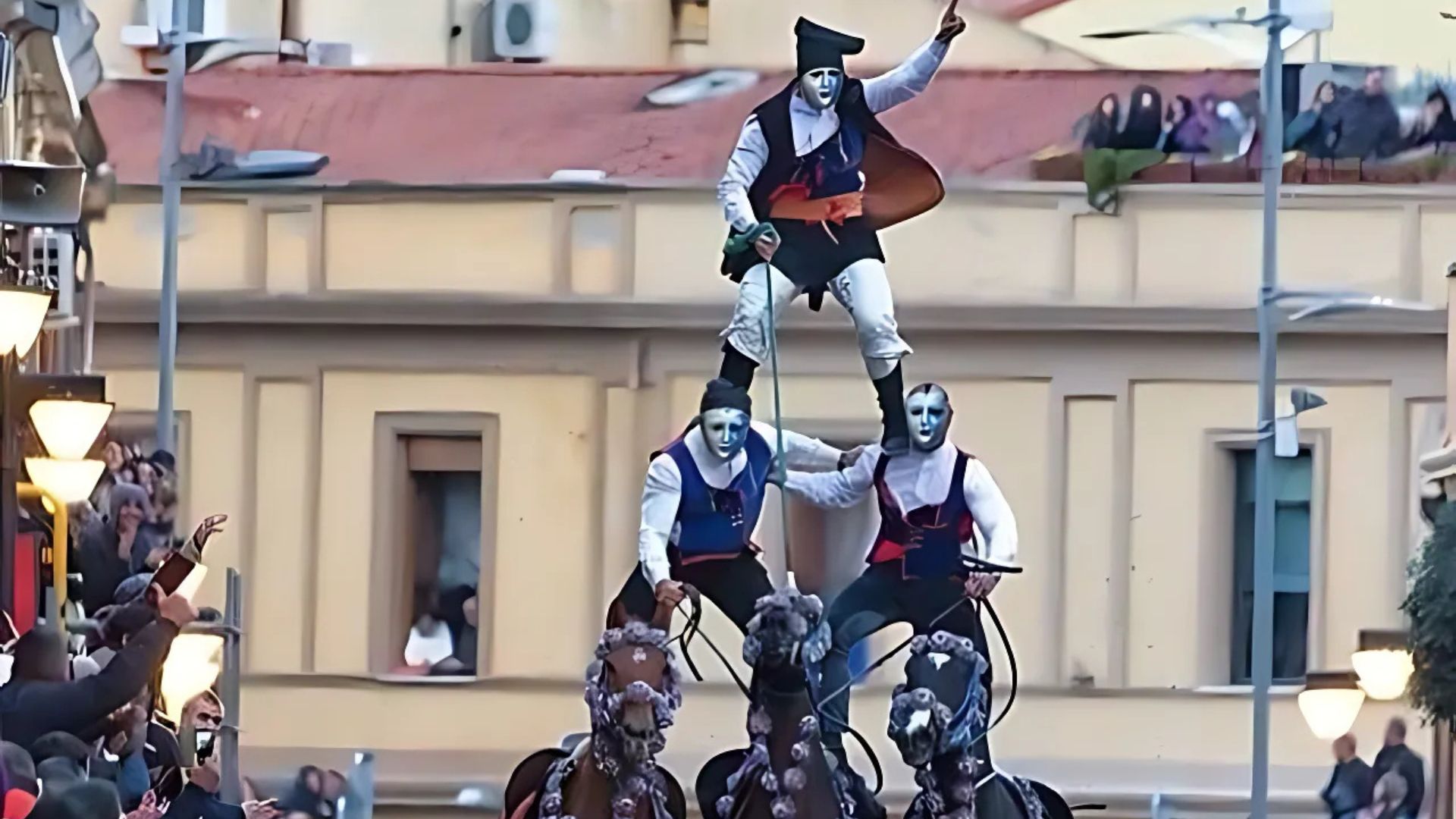 Image shows people doing dazzling horseback acrobatics at Sa Sartiglia festival,