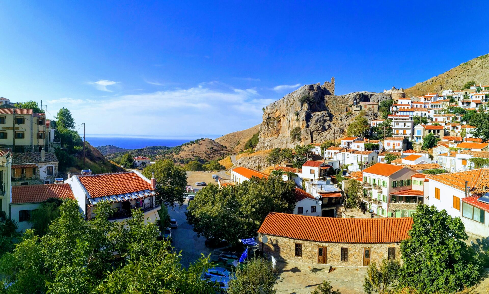 Traditional village on Samothrace Island with stone houses and mountain backdrop.