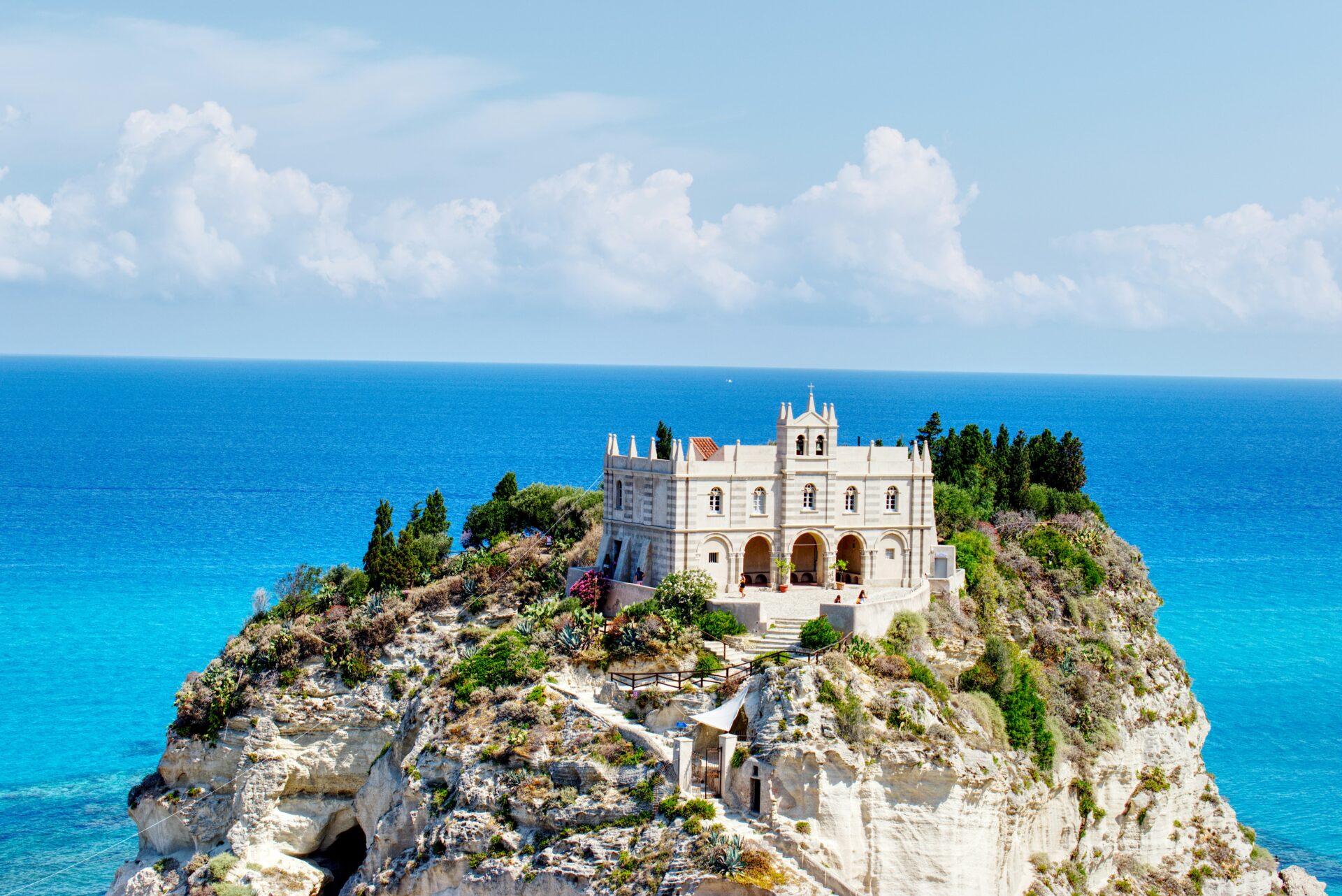 View of Santa Maria dell’Isola rising above the beach in Tropea, Italy