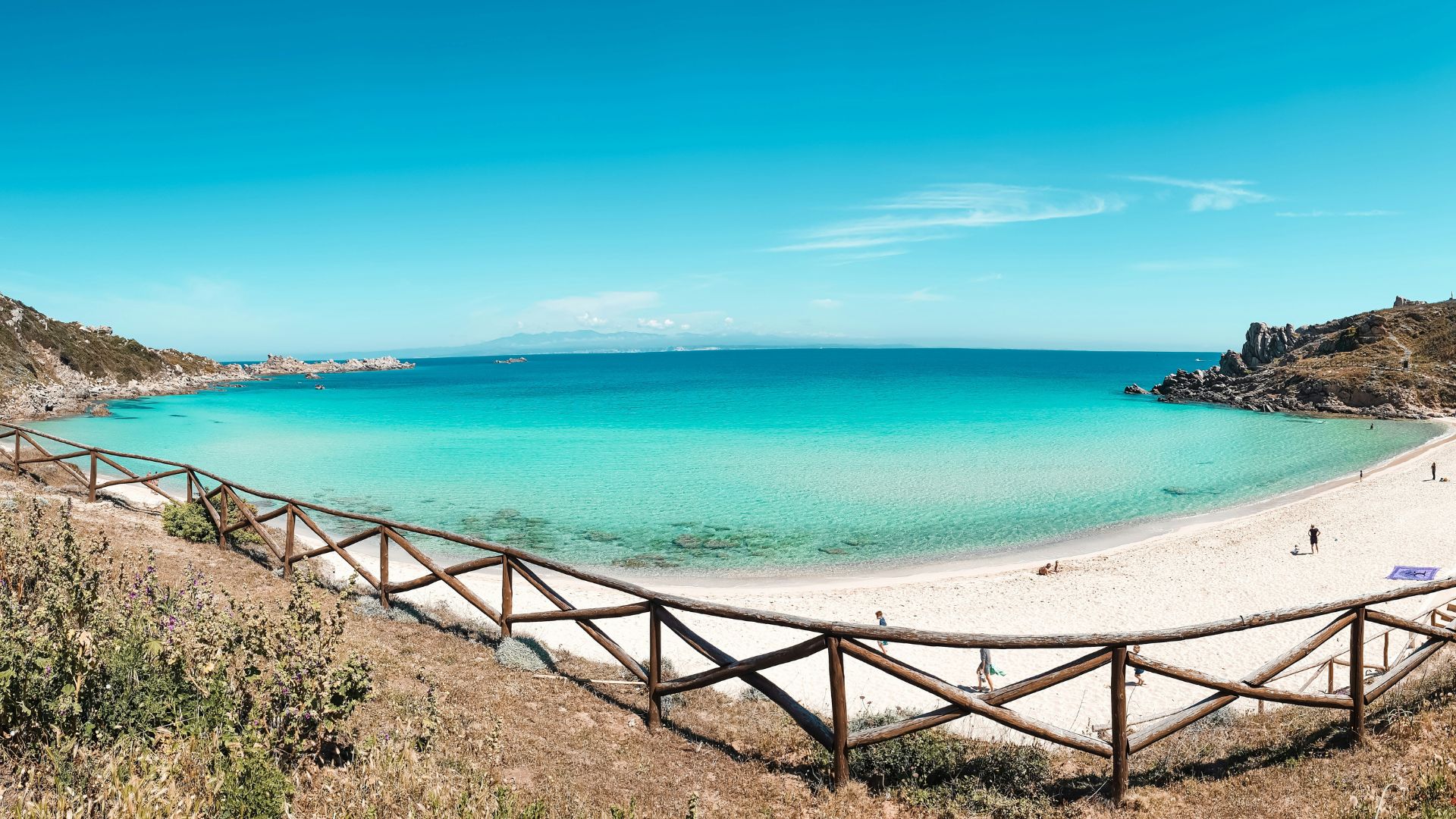 Scenic view of Santa Teresa Gallura, Sardinia, Italy characterized by pristine turquoise water and white sand beach.