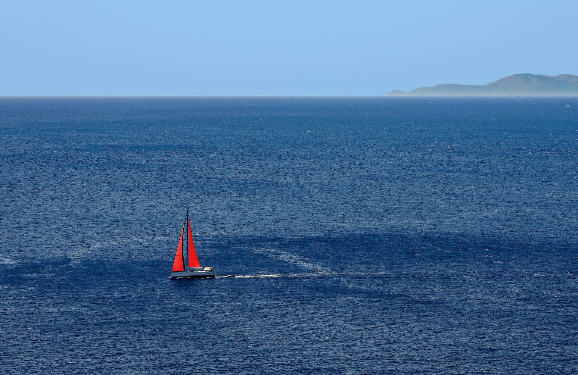 Saronic Gulf, Greece - gulf or sea with a red sailboat