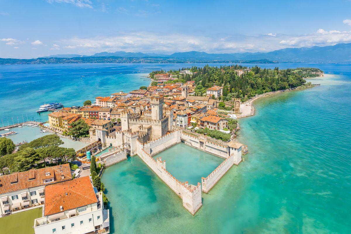 Aerial view of Sirmione, Italy, showcasing the Scaliger Castle and the town's peninsula location on Lake Garda.