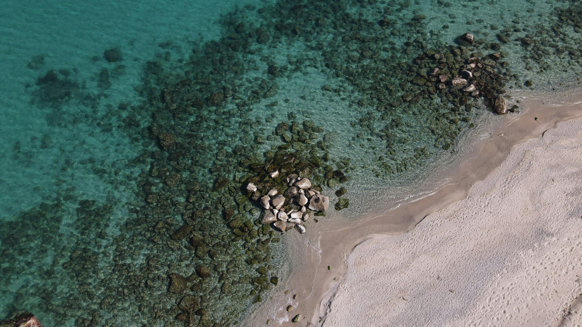 Crystal-clear waters at Soverato Beach gently lapping against the golden sand,