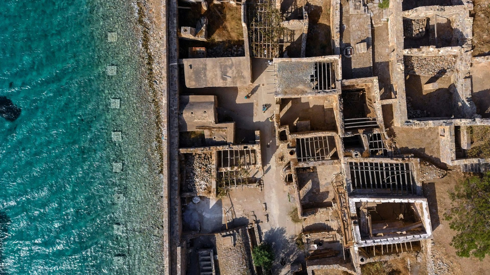 Spinalonga Island, Crete, featuring the Venetian fortress ruins surrounded by turquoise waters.