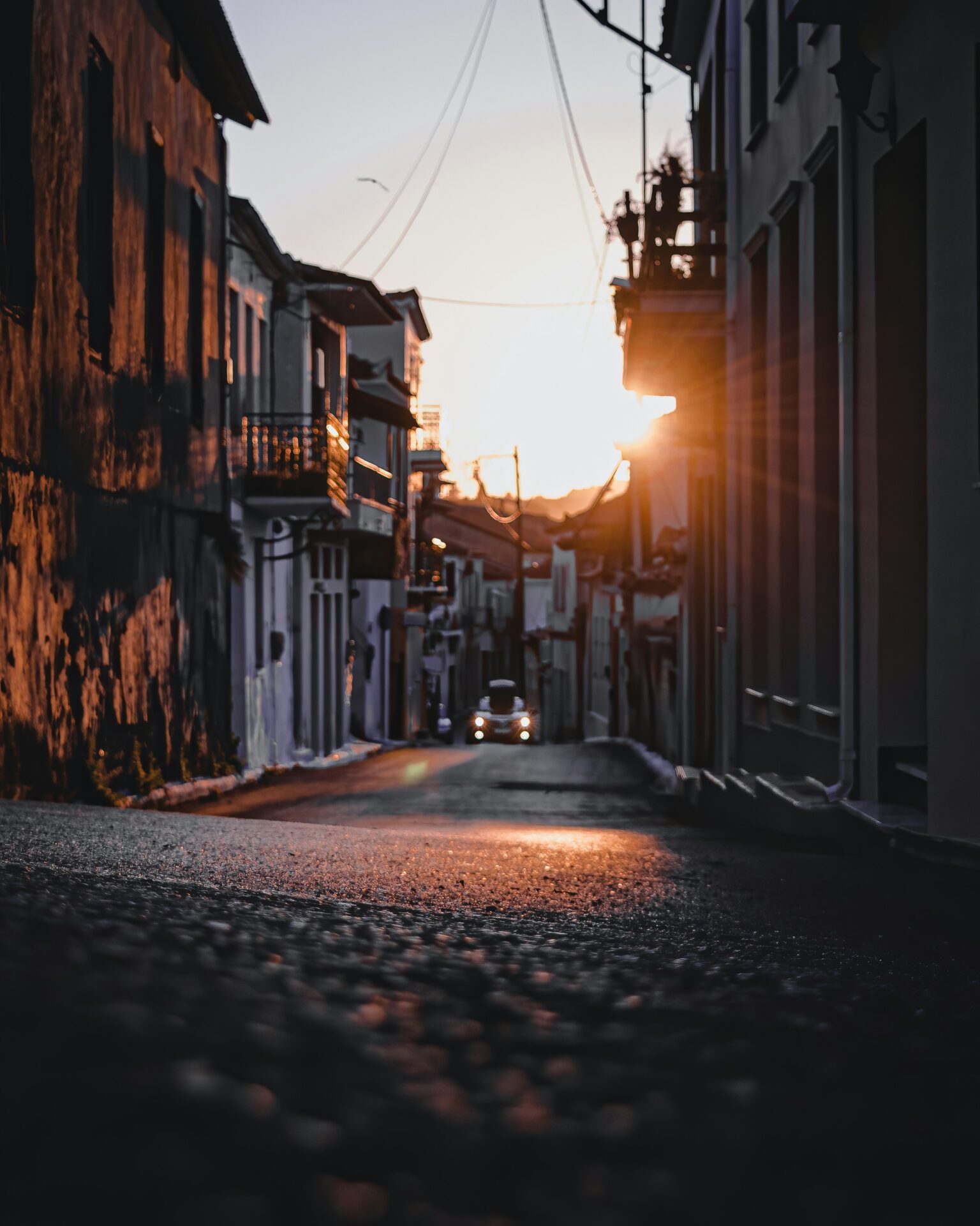 A narrow, sunlit street in Koroni