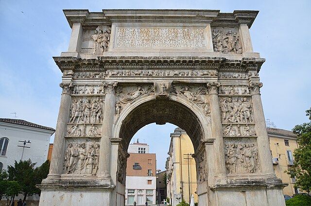 The Arch of Trajan in Benevento, Italy, a well-preserved Roman triumphal arch with intricate carvings and inscriptions.