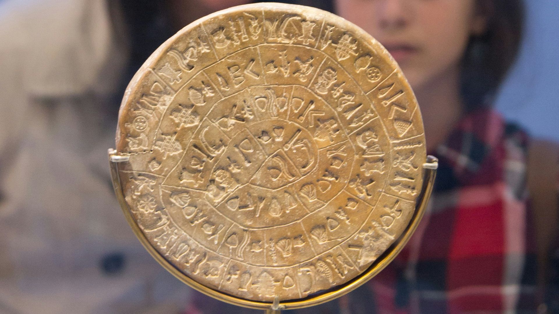The Phaistos Disc, a clay disc covered in undeciphered symbols, on display at the Heraklion Archaeological Museum.