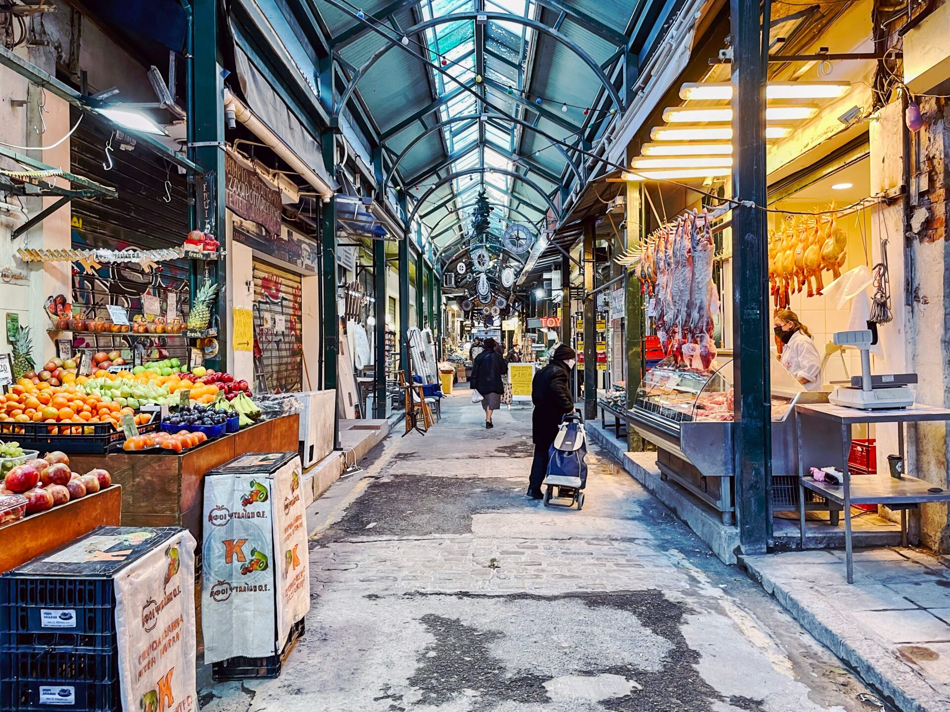 Fresh vegetables, olives, and seafood displayed at an open-air market in the heart of Salonica.