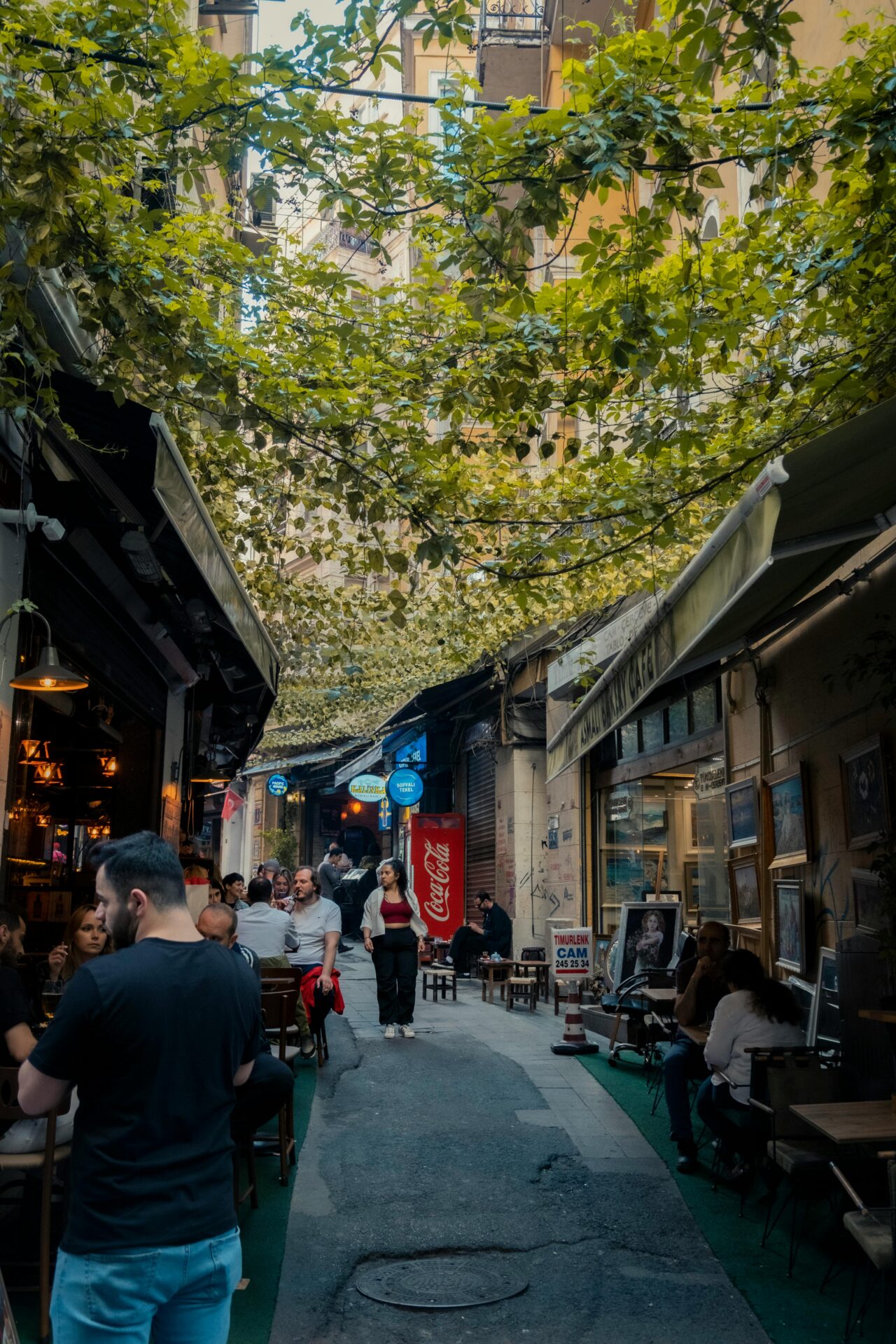 Street in Thessaloniki lined with buildings and a cozy sidewalk café