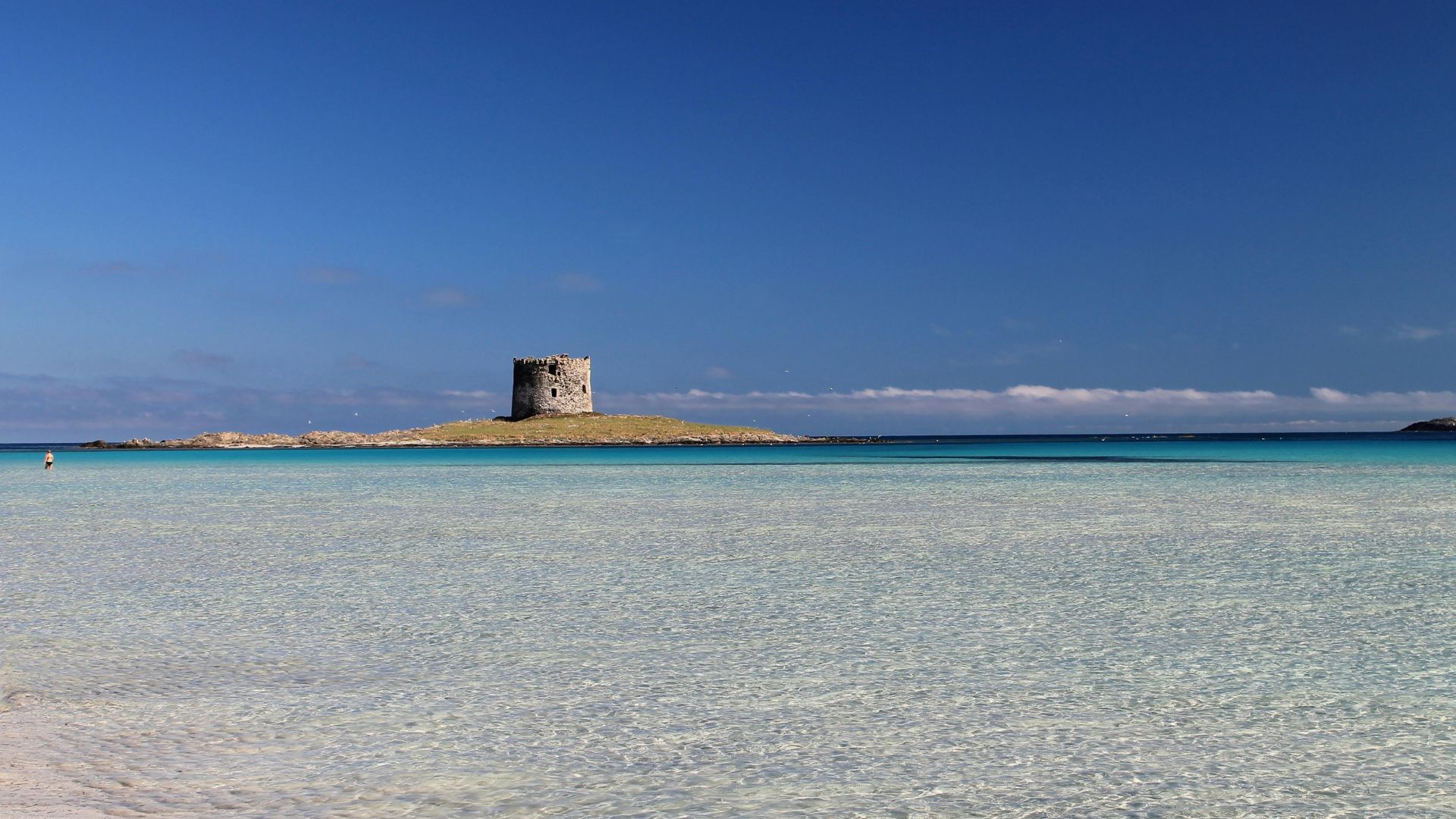 Torre della Pelosa, a historic stone tower on a small island, surrounded by the sea