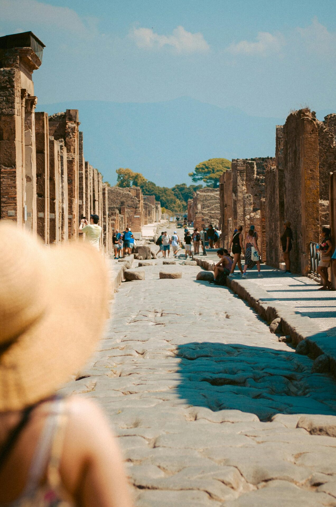 Tourists Exploring Ancient Ruins of Pompeii