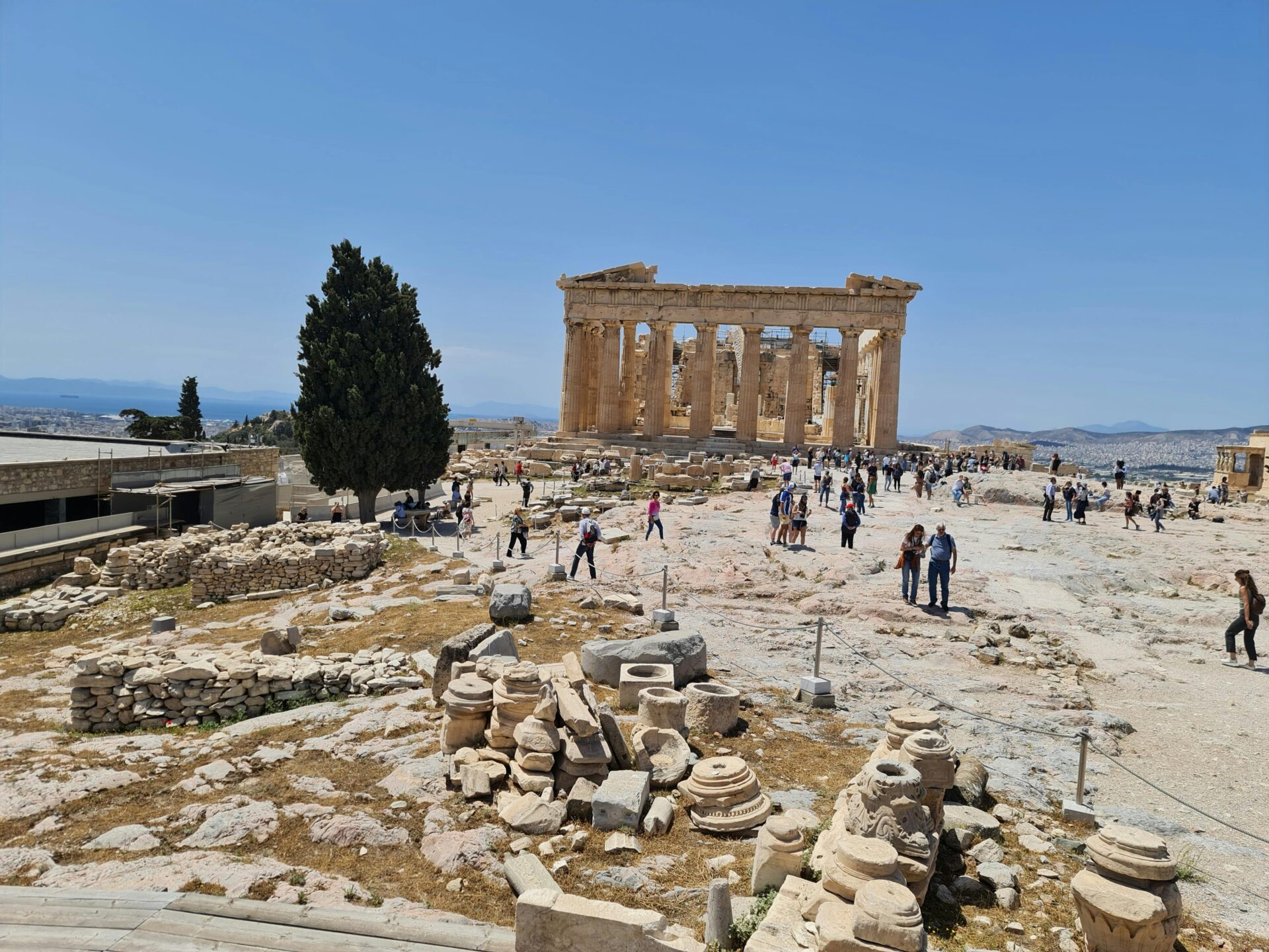 Tourists Visiting Ancient Ruins in Acropolis Athens