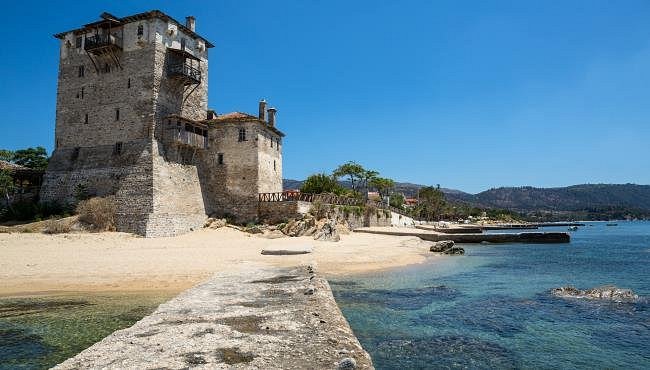 Byzantine Tower of Ouranoupolis standing at the edge of the beach