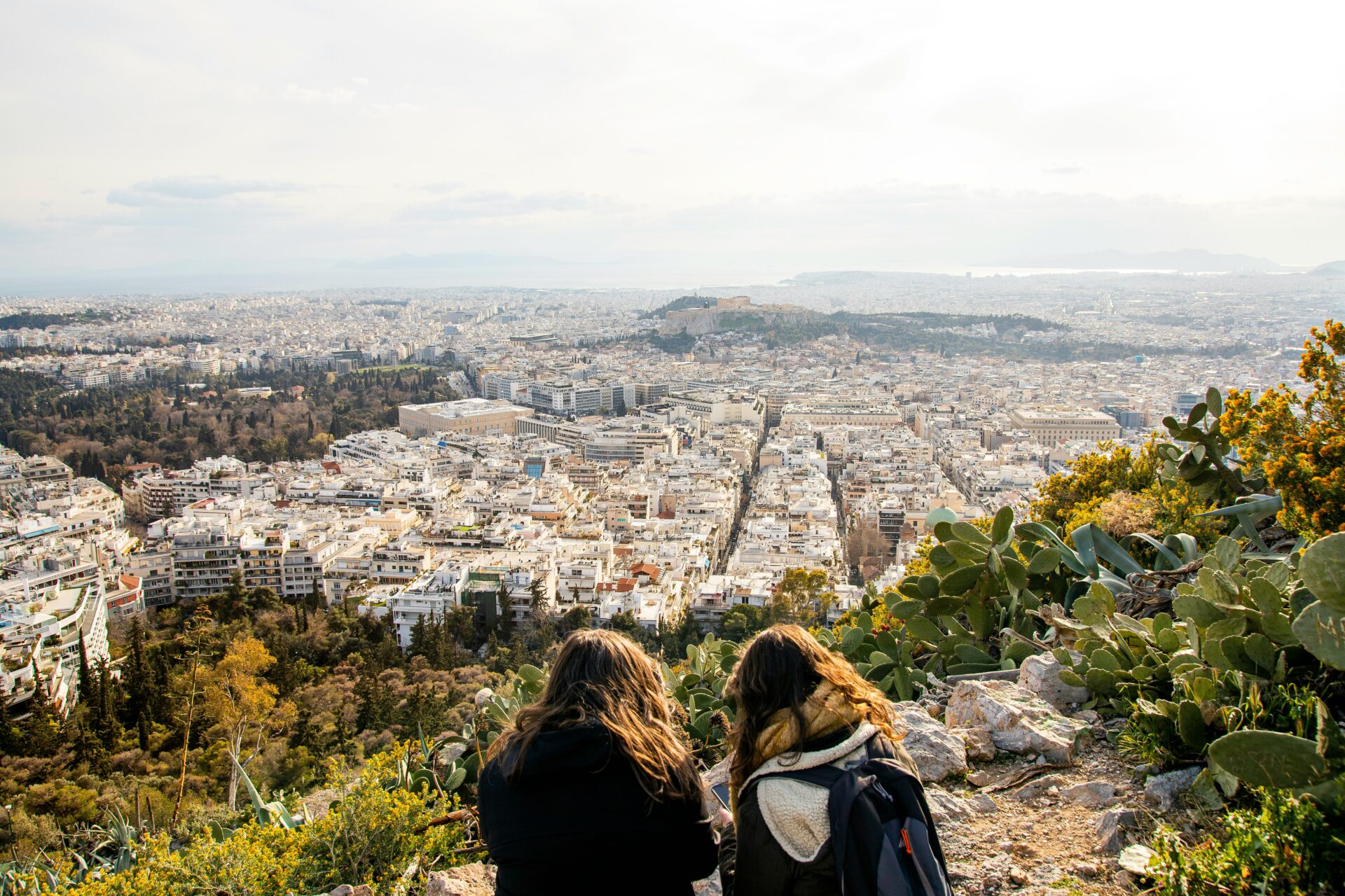 Two girls looking across the city of Athens from Lycabettus Hill