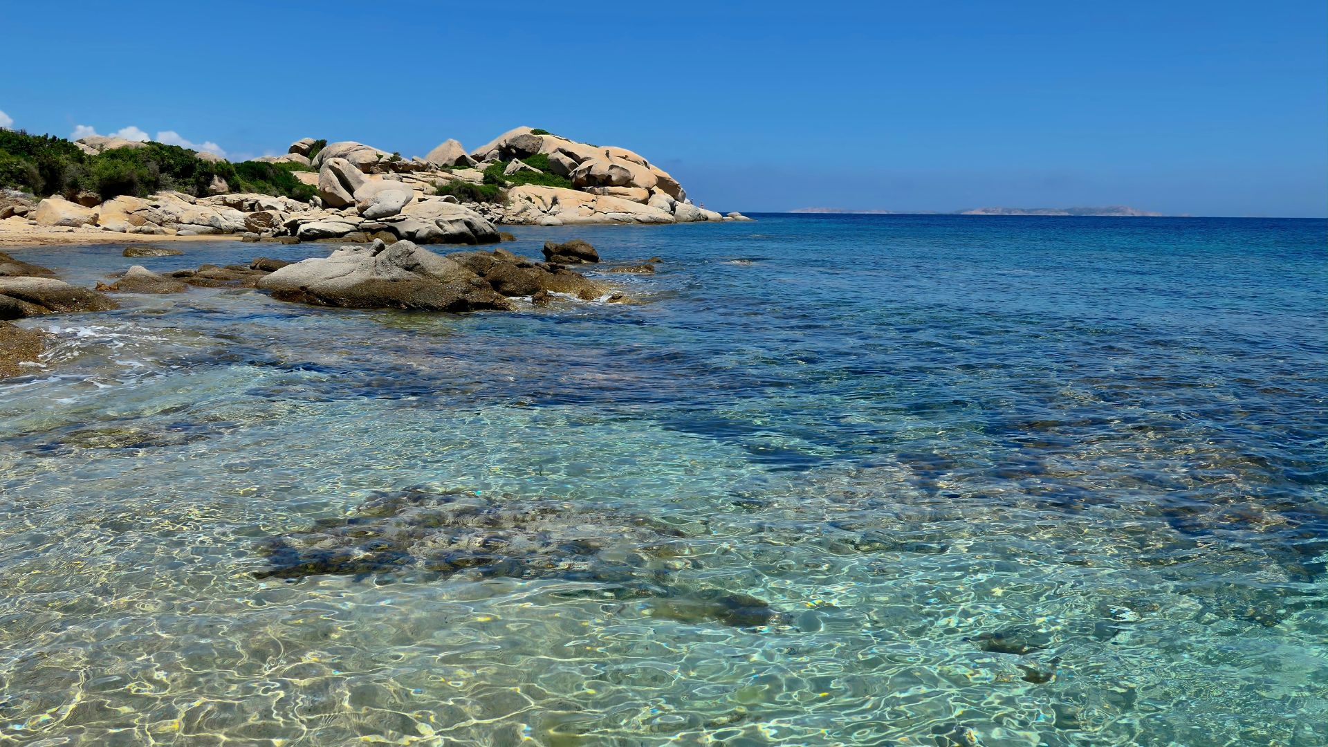 Scenic view of Santa Teresa Gallura, Sardinia, Italy characterized by pristine blue water and rocky cliffs,.