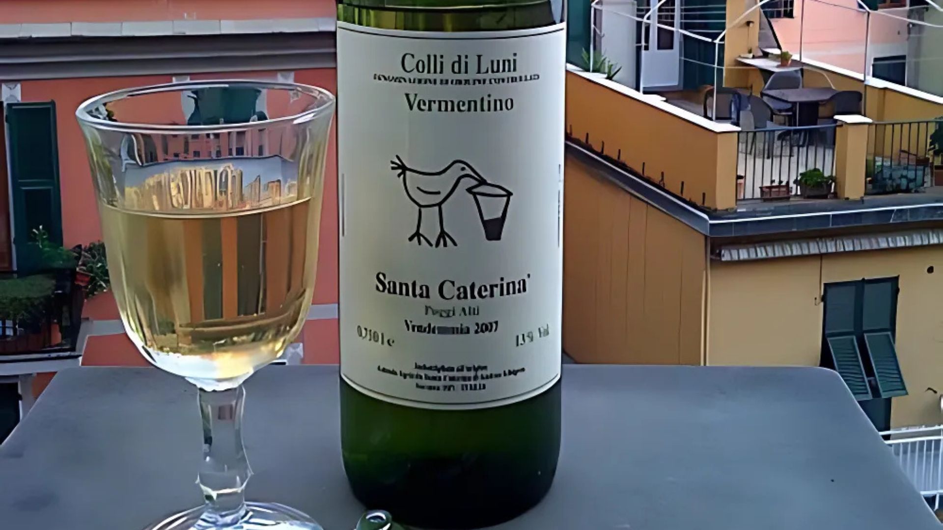A bottle and a glass of Vermentino wine.