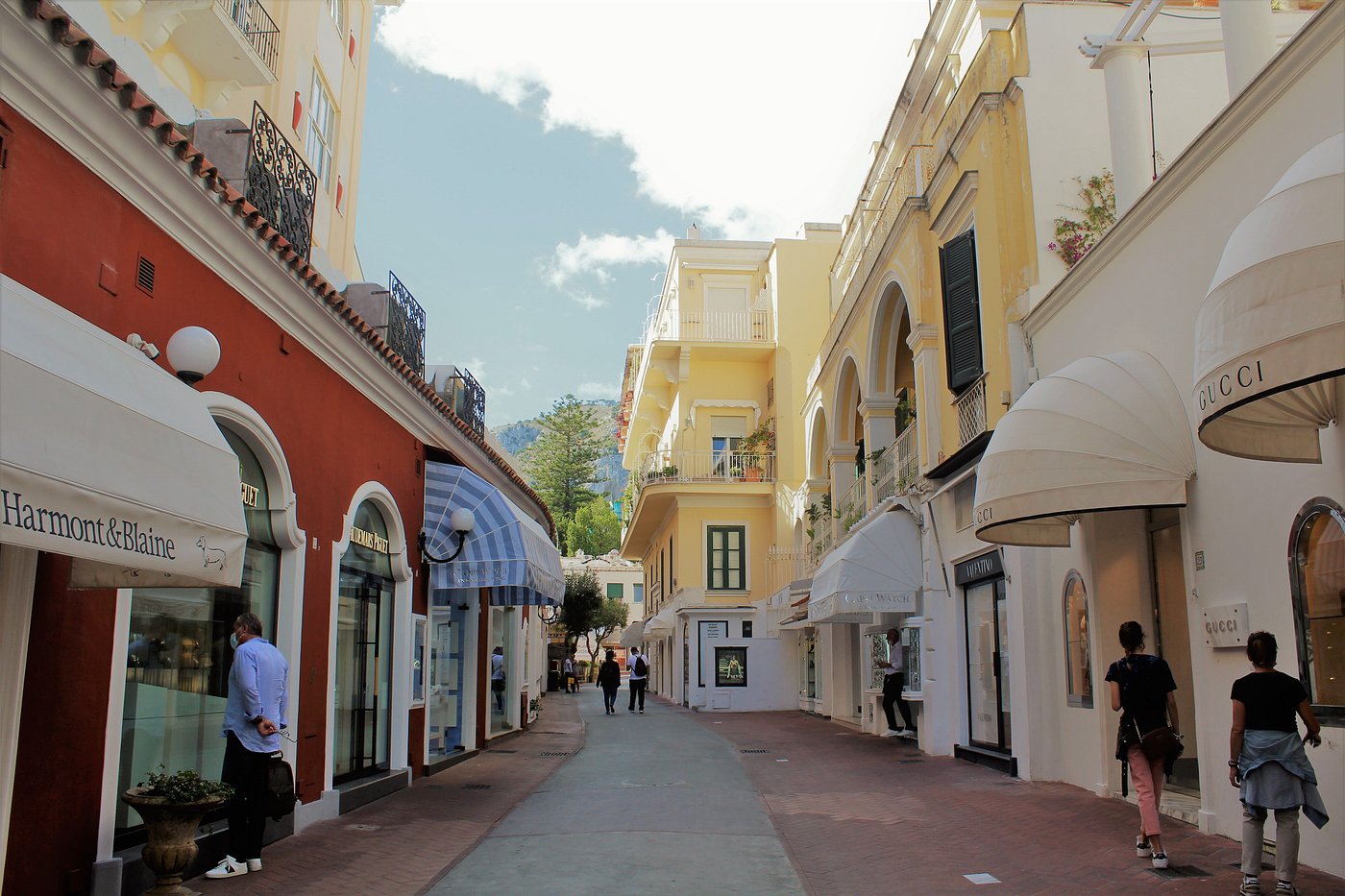 Charming street in Capri lined with luxury boutiques and colorful buildings on Via Camerelle.