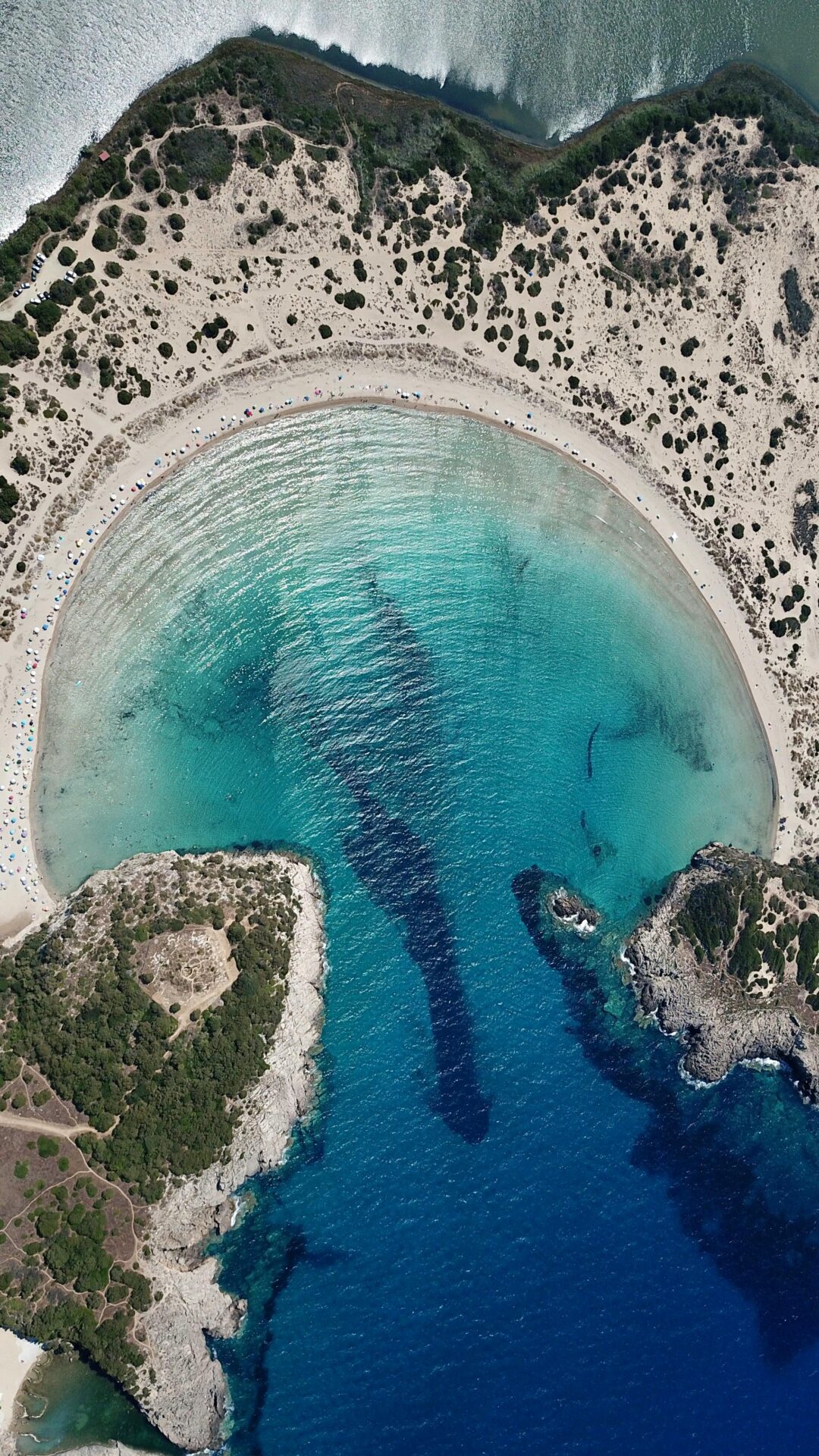 Panoramic view of Voidokilia Beach from Paleokastro Hill, showing the beach’s curve