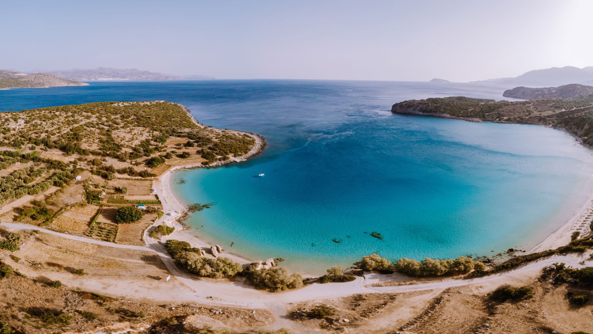Aerial view of Voulisma Beach, Crete, with its turquoise waters and white sand.