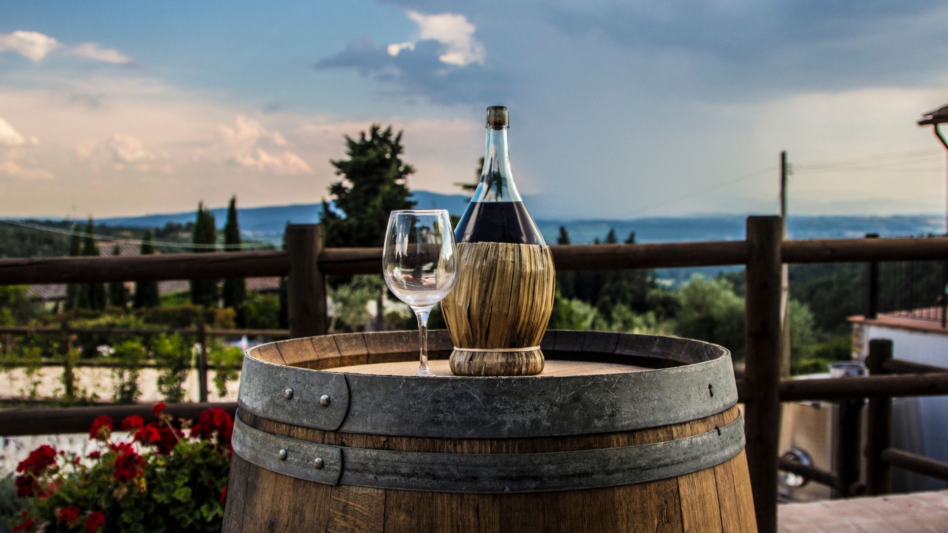 Wine bottle and glass on top of a
barrel.