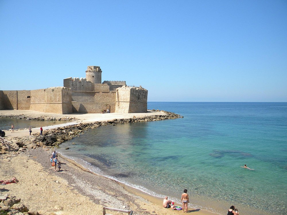 Le Castella - tourists swim at the beach