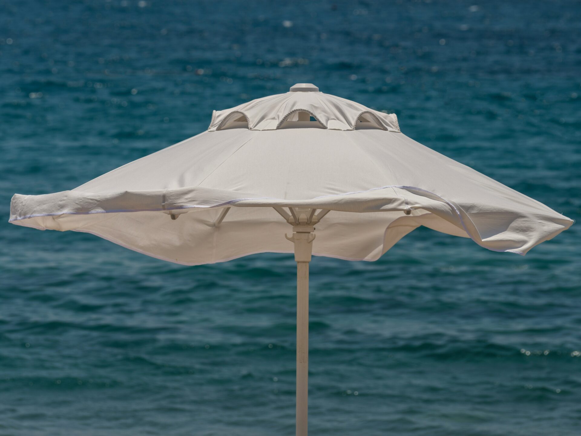 White beach umbrella and peaceful sea view