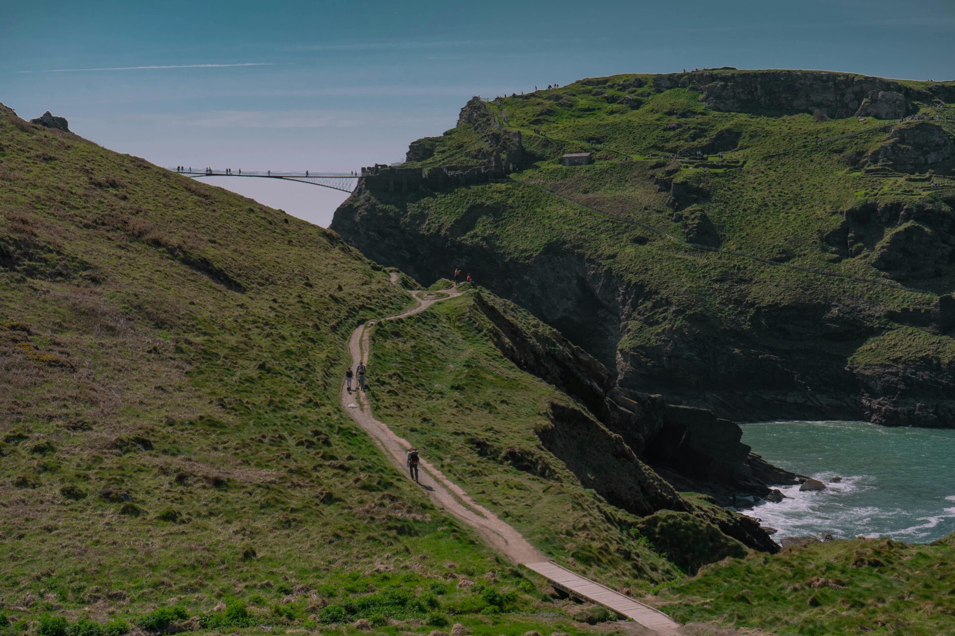 Footbridge at Tintagel Castle spanning two rocky cliffs above the sea