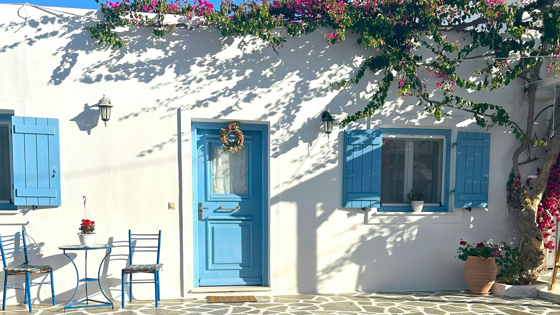 Outdoor seating area with bougainvillea in Antiparos, Greece.