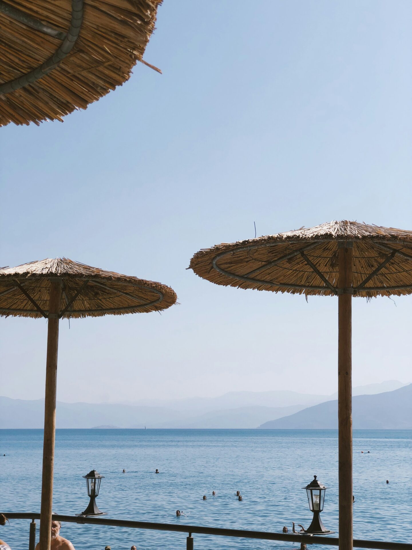 Beach bar in Greece with native canopies and a view of the coast or sea