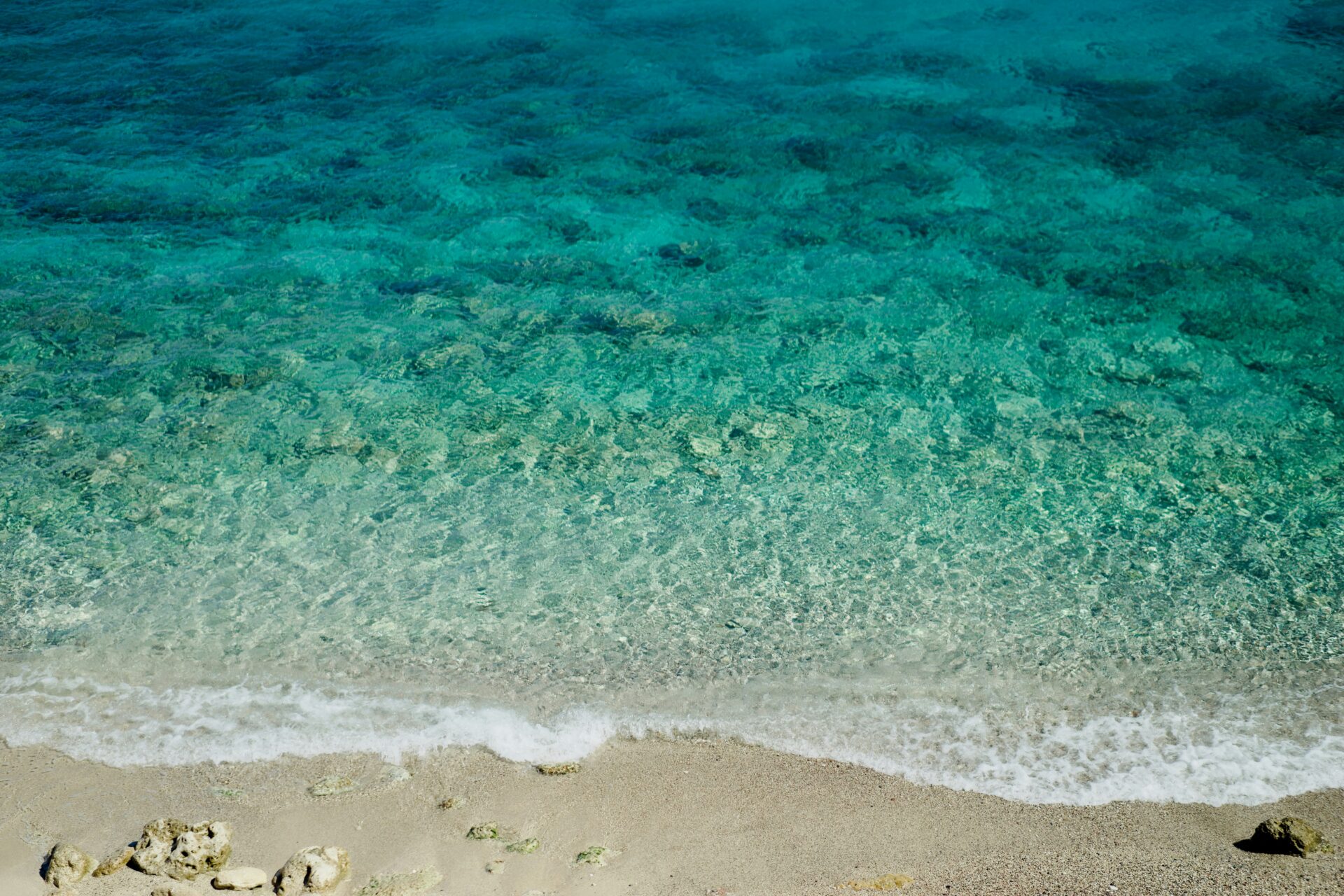 Beach sand with clear seawater - beach in Greece