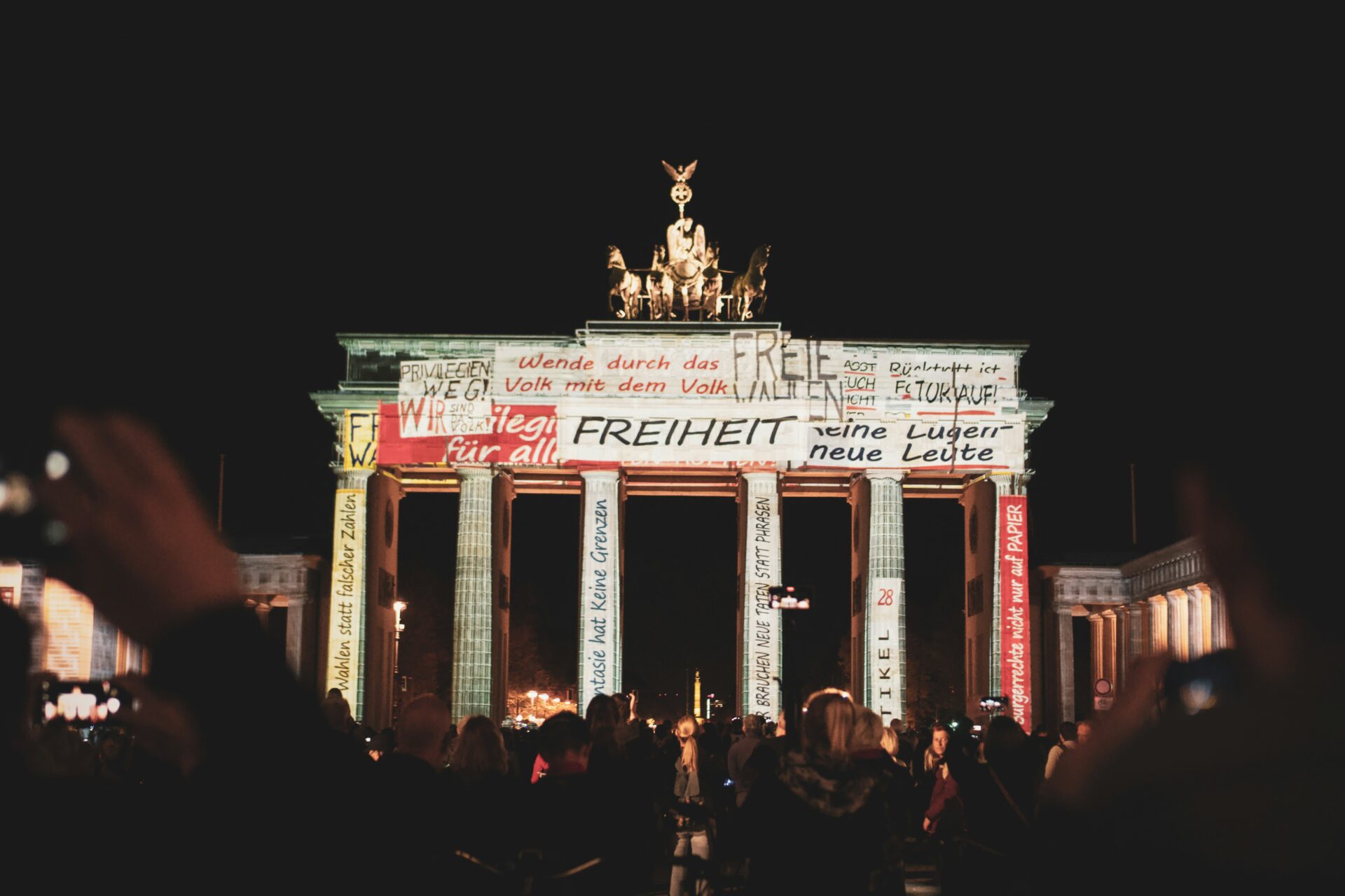 Light projection showing abstract patterns on the columns of the Brandenburg Gate.