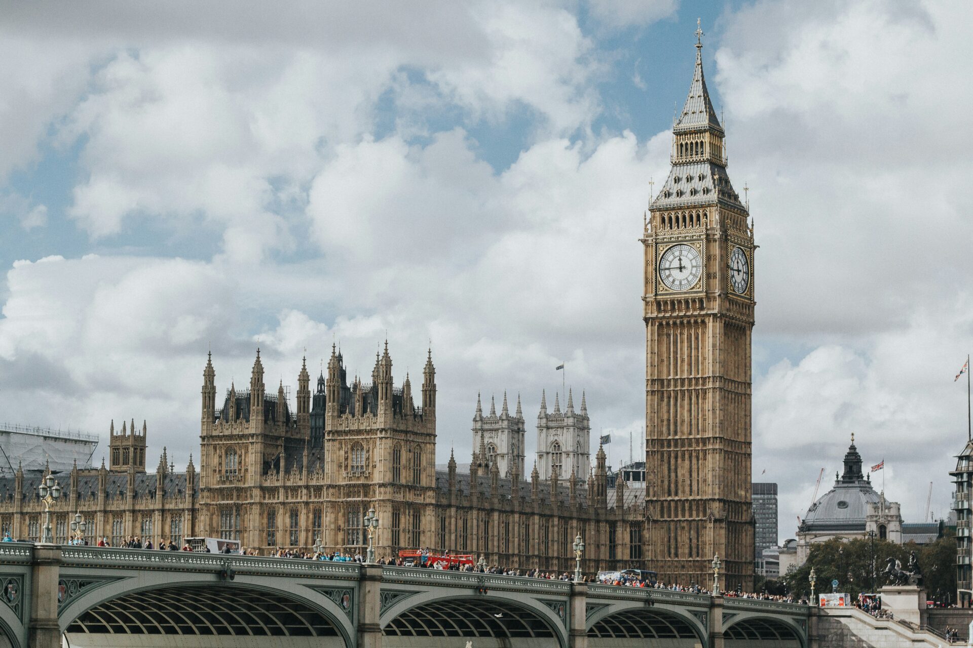 Iconic Big Ben clock tower and UK Parliament overlooking the Thames River in London.