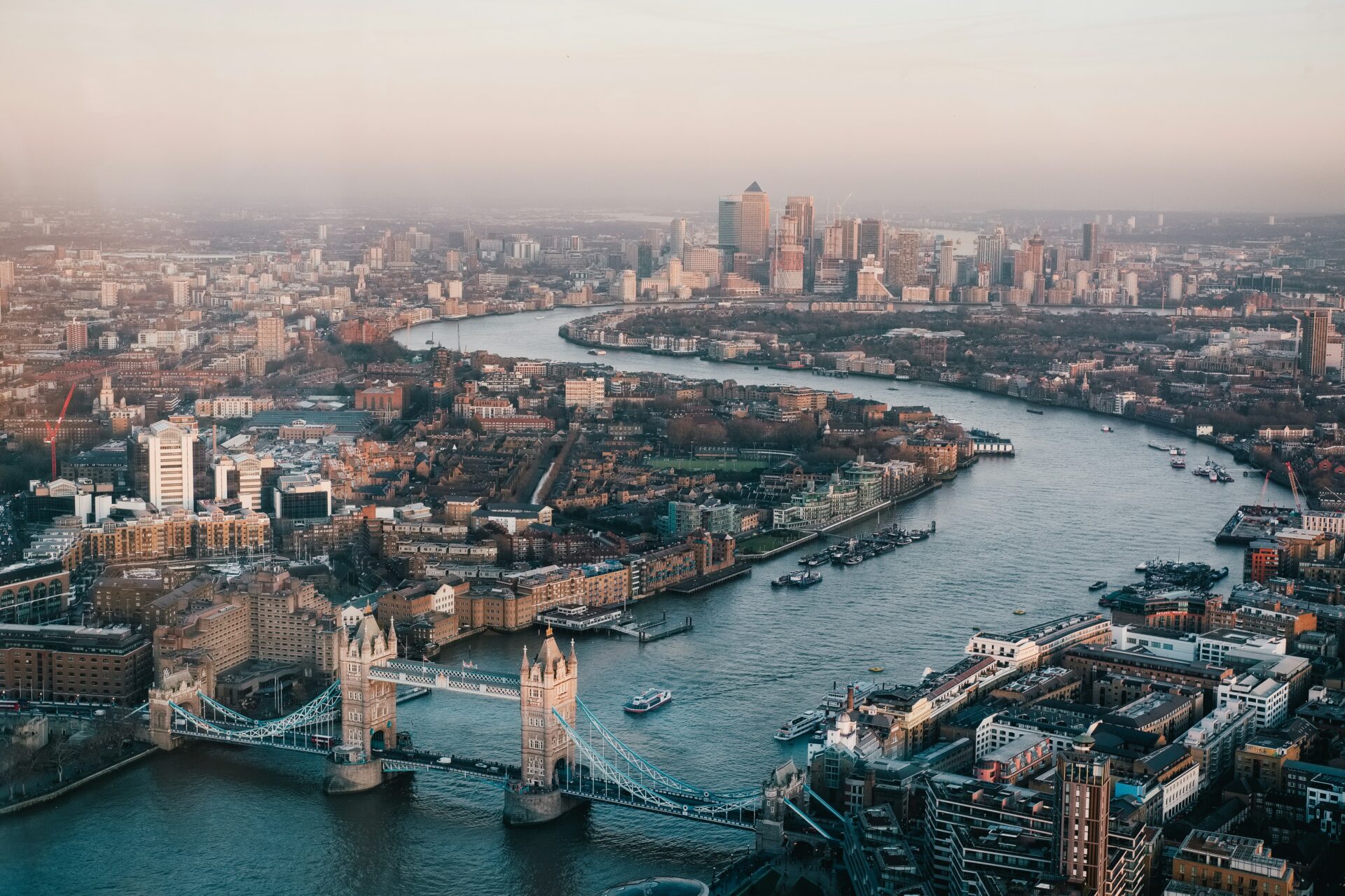 Bird’s-eye view of London cityscape with River Thames and iconic landmarks.