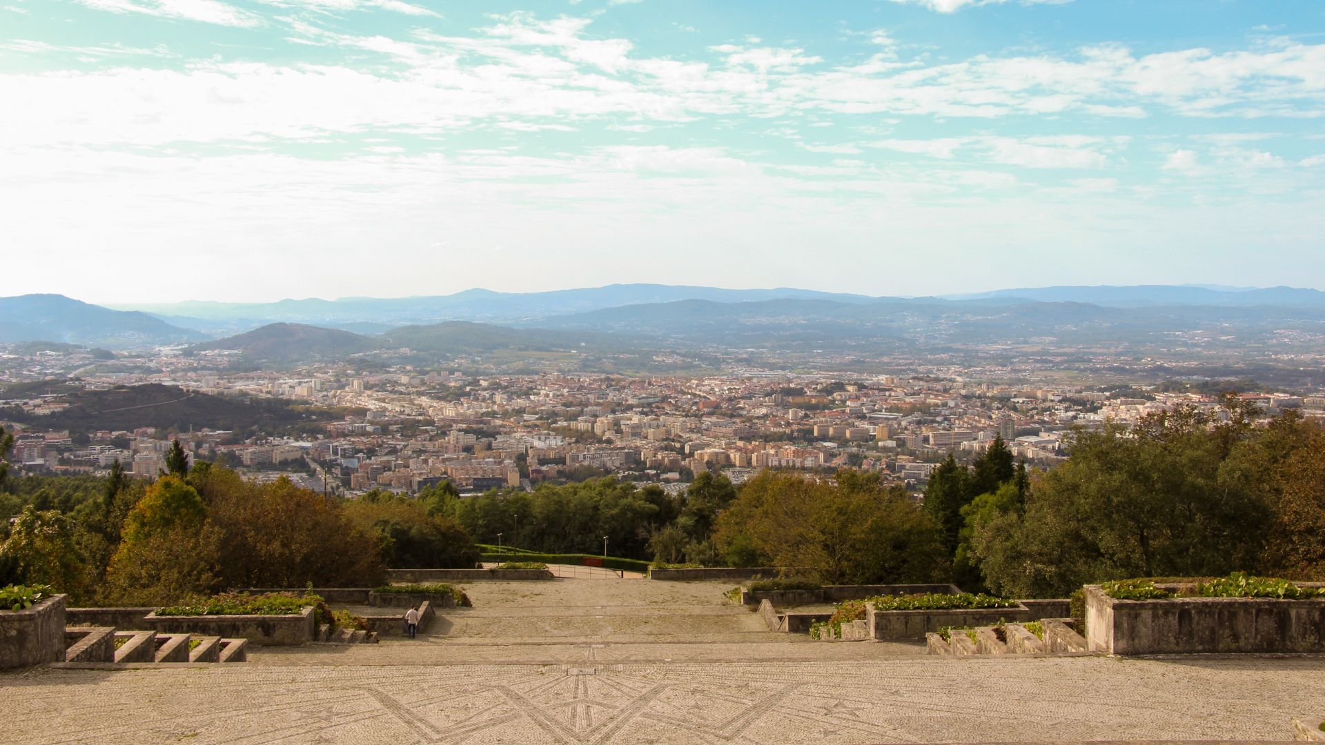 Panoramic view from the Sanctuary of Our Lady of Sameiro overlooking the city of Braga, Portugal, with mountains in the background.