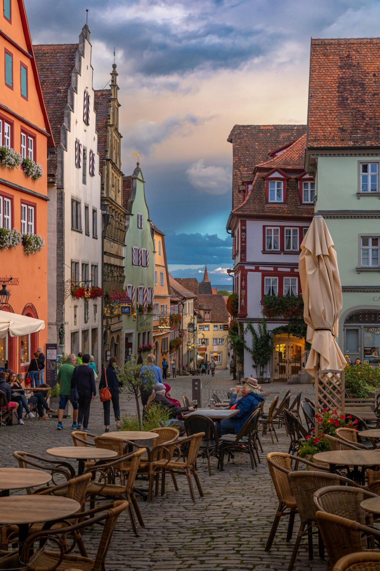 Bustling old town street with shops and outdoor cafés in Rothenburg