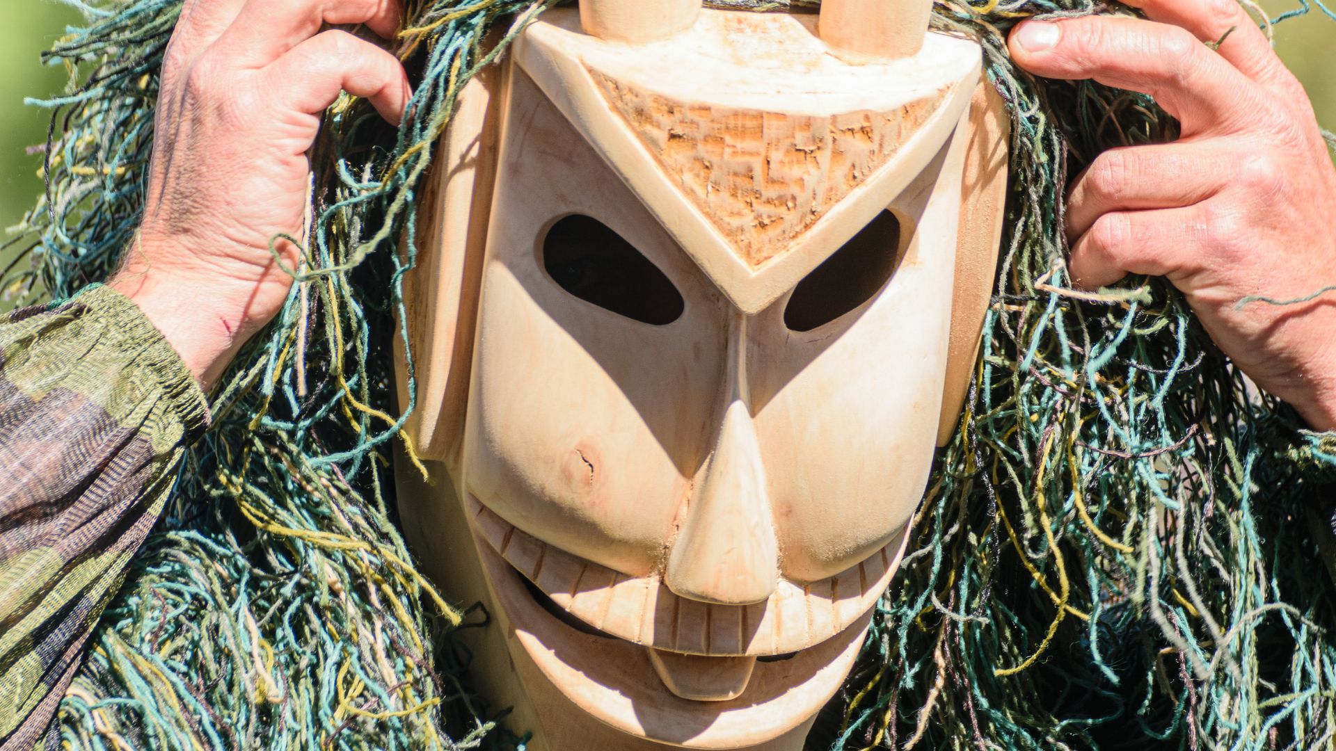 The image is a Caretos mask, which is a traditional figure associated with the Entrudo (Carnival) festivities, particularly in the Trás-os-Montes e Alto Douro region of northern Portugal. 