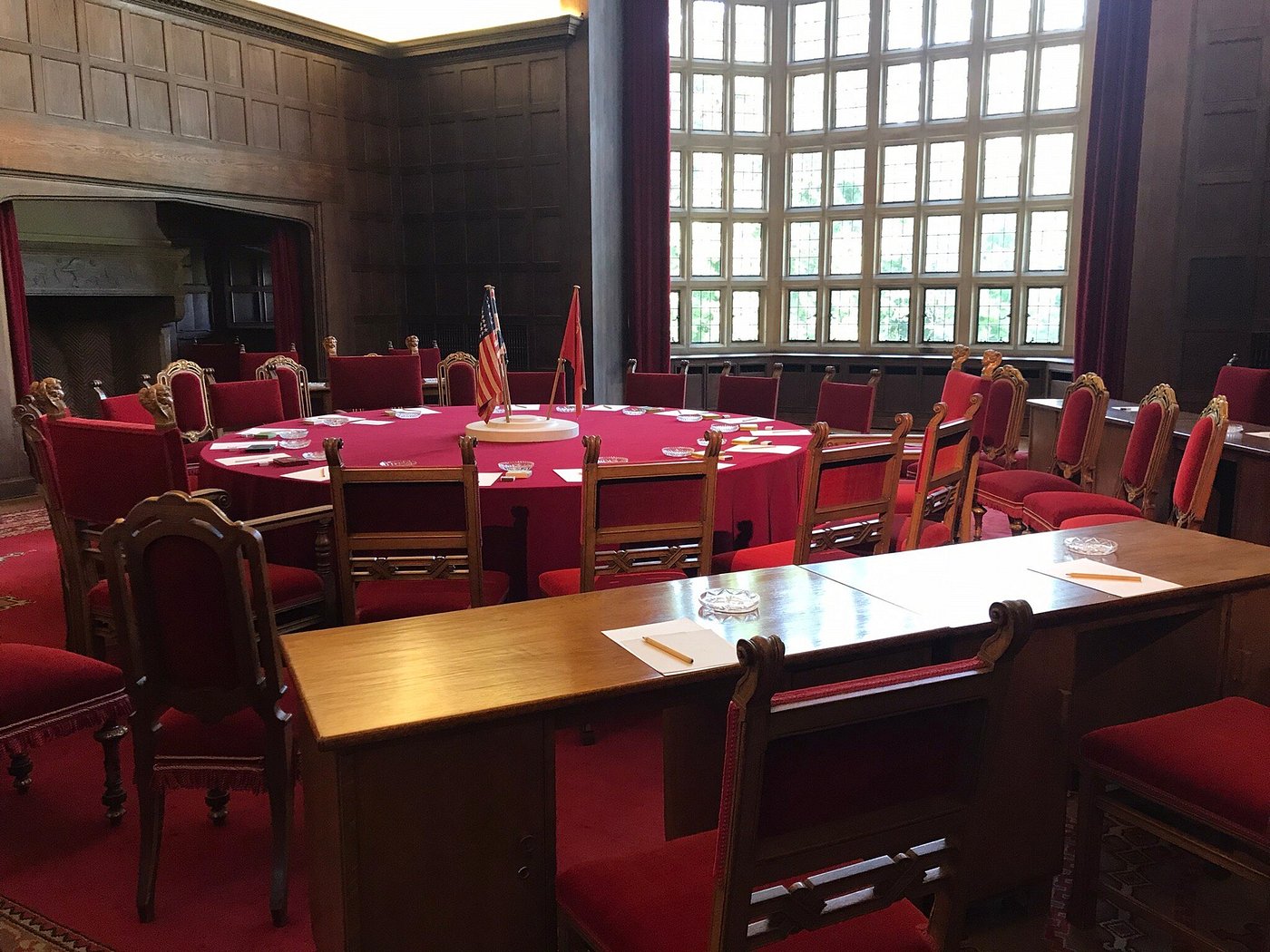Historic round table and red chairs inside Cecilienhof Palace, where Allied leaders met during the Potsdam Conference in 1945