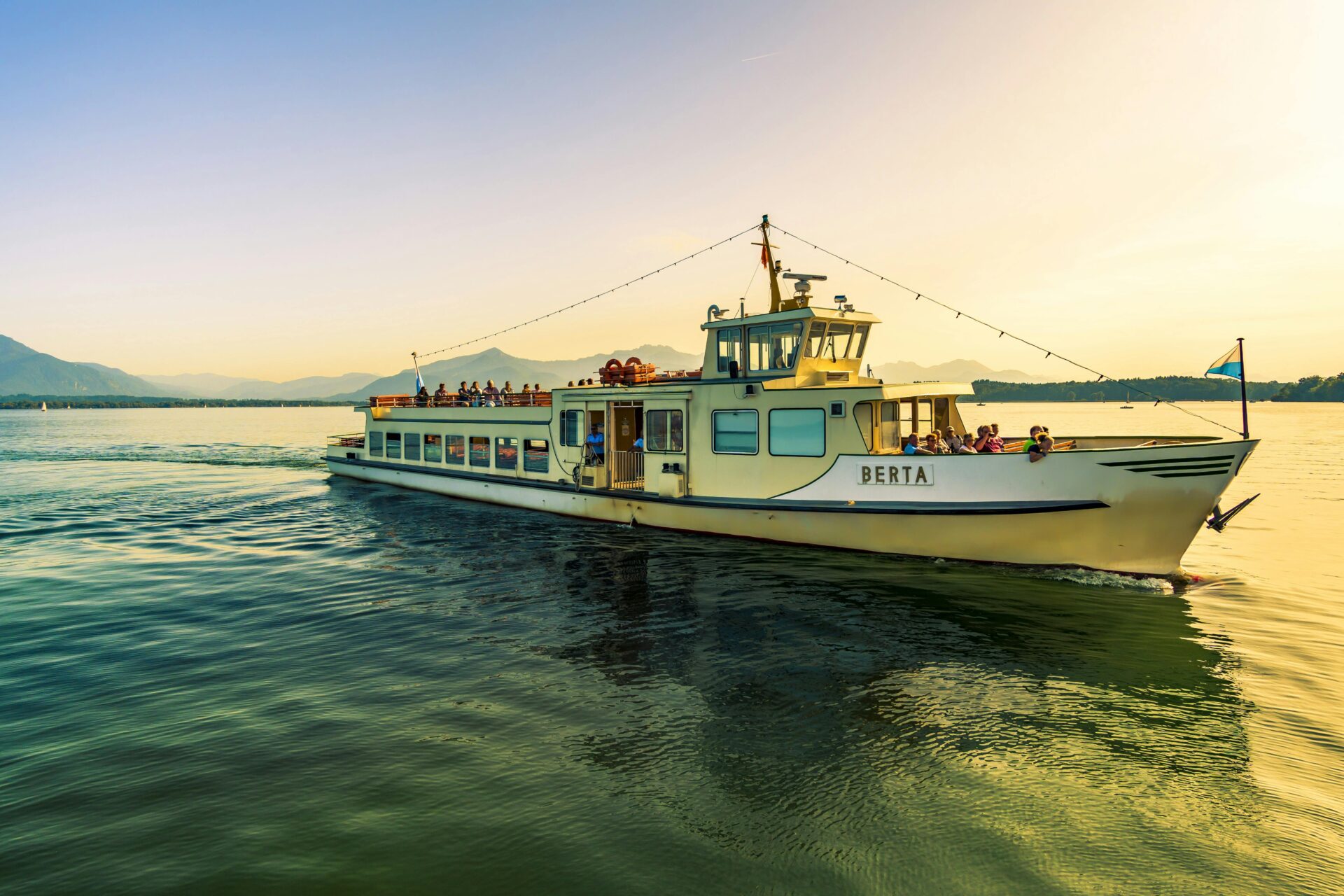 Tour boat crossing Chiemsee Lake toward Herreninsel Island