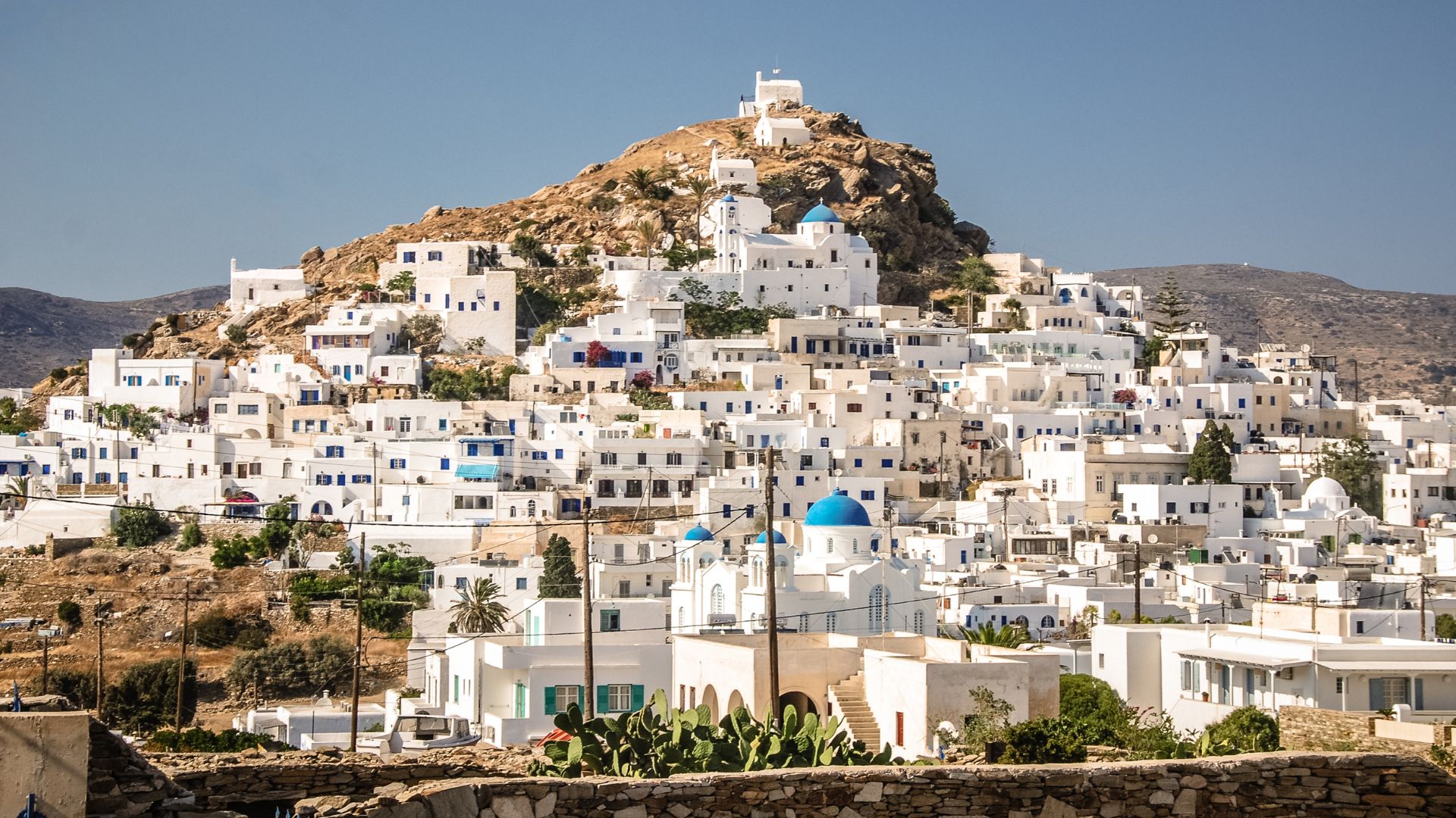 Chora, the main town of Ios, Greece with white buildings on a hill