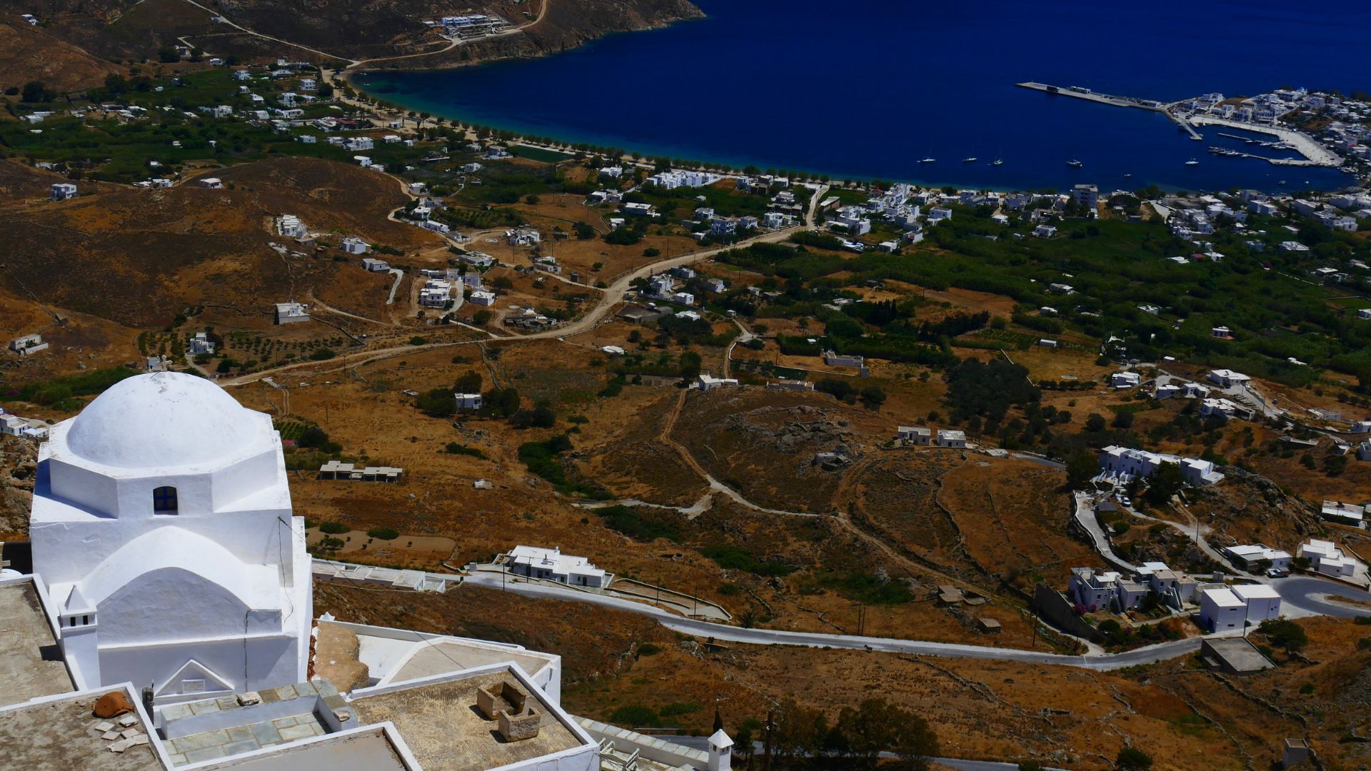 View of Chora, Serifos, Greece, showing whitewashed buildings and the Aegean Sea.