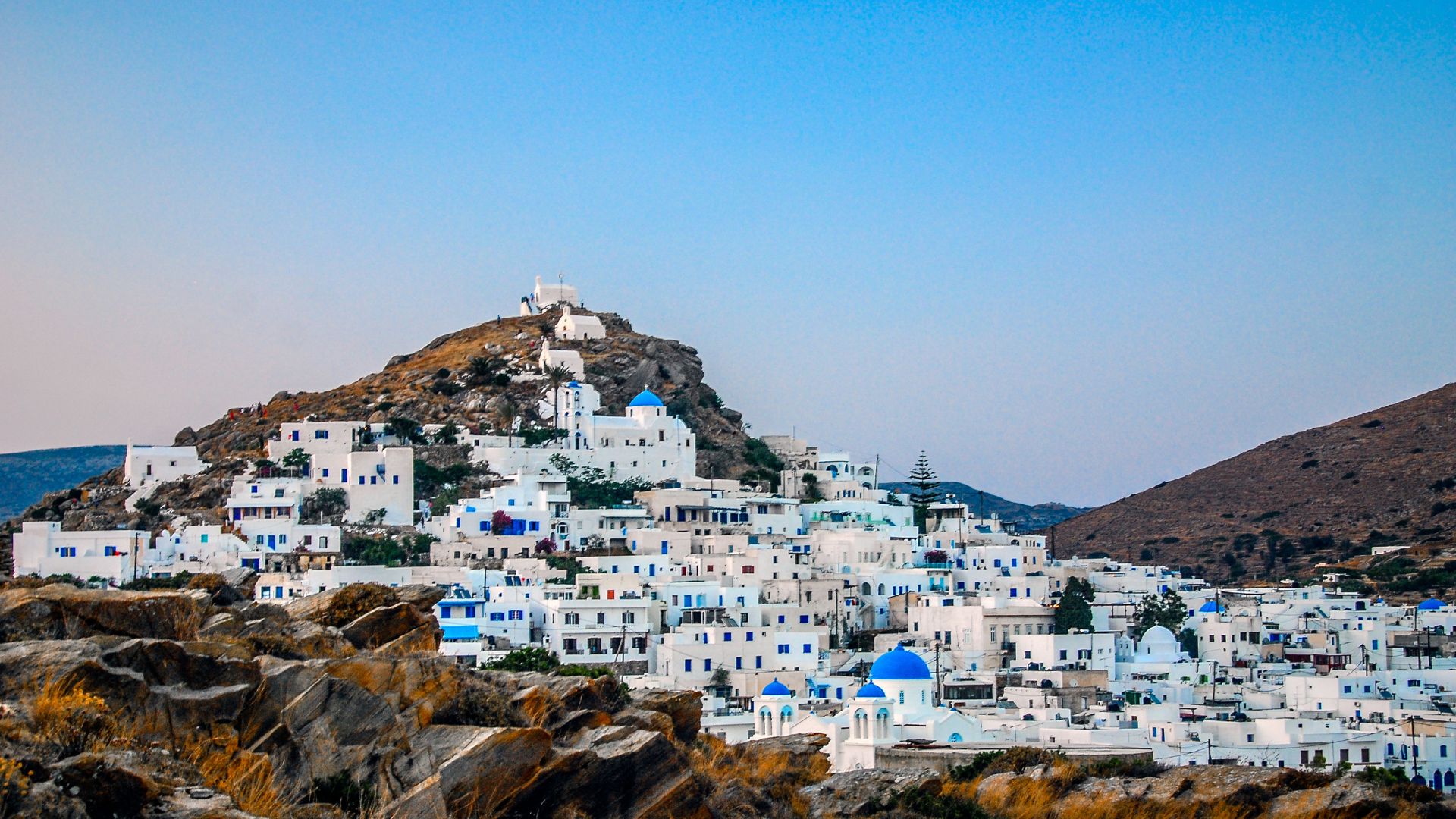 Chora, the main town of Ios, Greece with white buildings on a hill