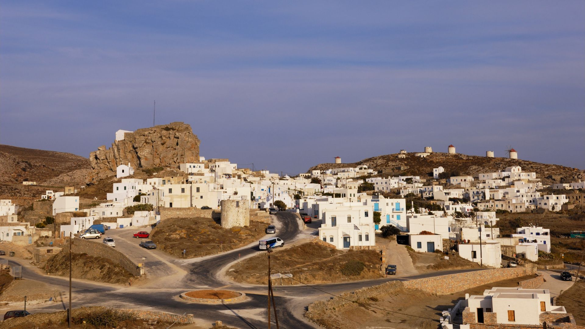 A panoramic view of Chora village in Amorgos, Greece, with its white buildings and windmills.