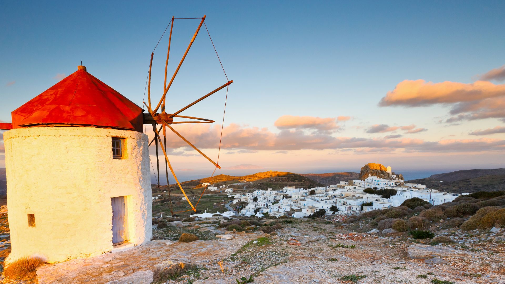 Windmills and village visible in Chora, Amorgos, Greece.