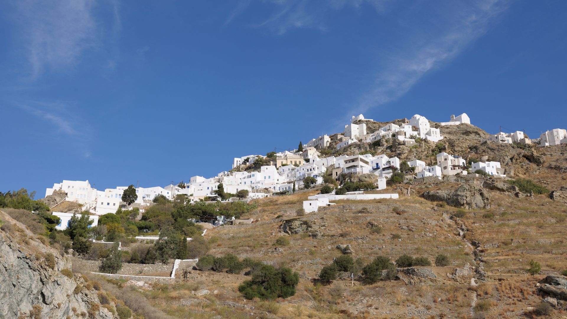 A hillside village with white buildings in Serifos, Greece.