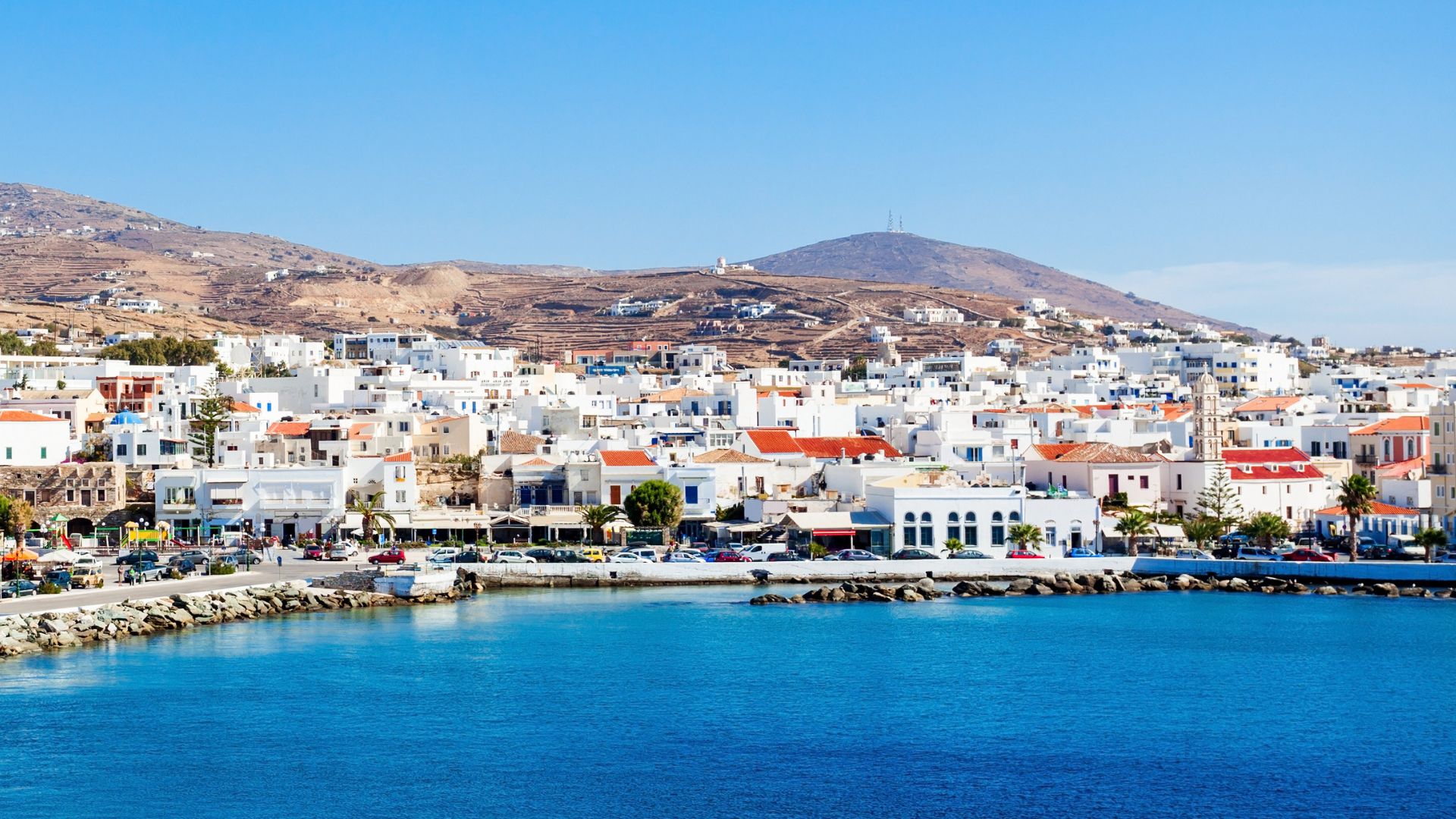 A coastal town with white buildings in Tinos, Greece.