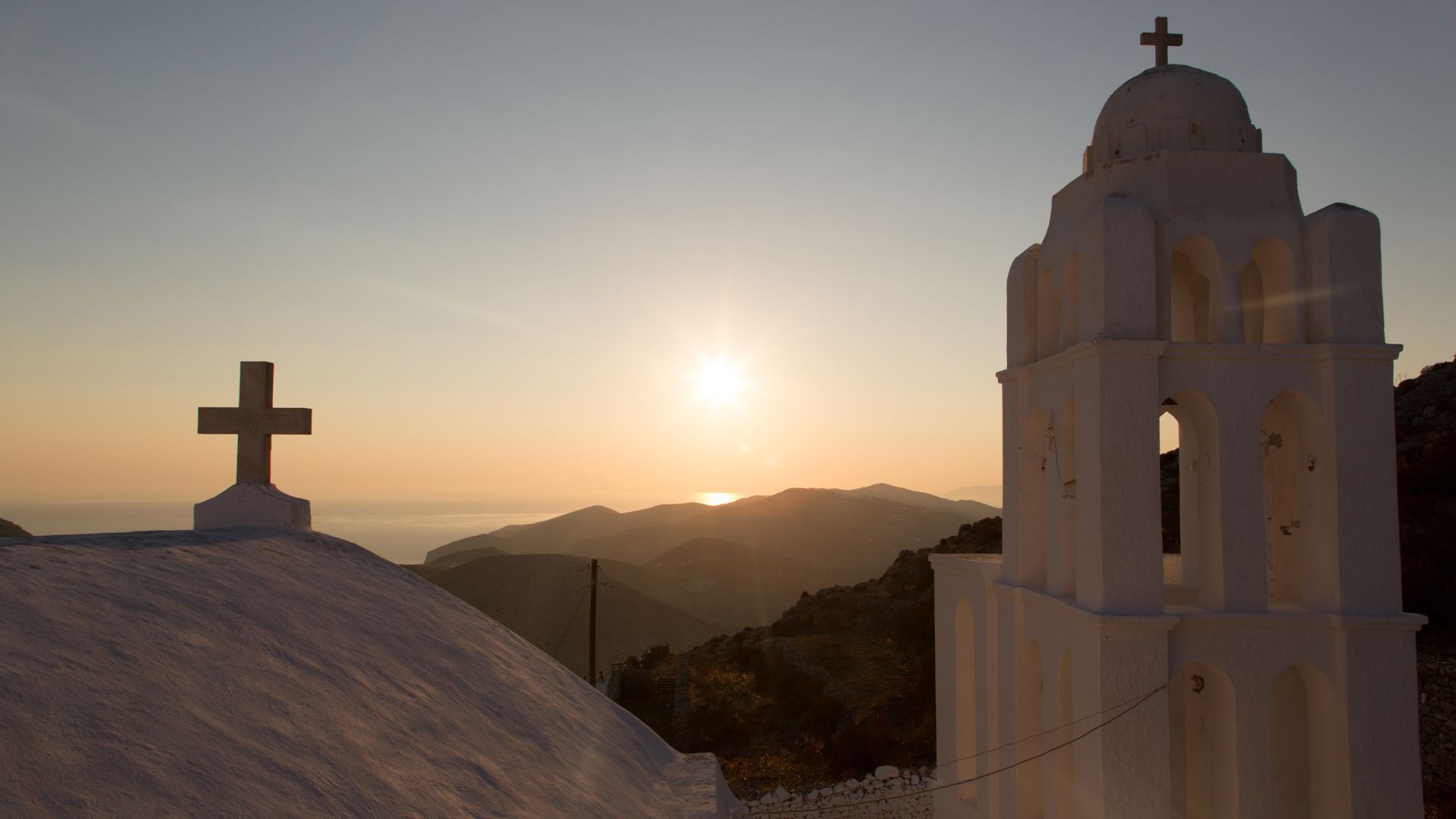 Church of Panagia (Church of the Virgin Mary) in Chora, Folegandros, Greece perched on a hill at sunset.