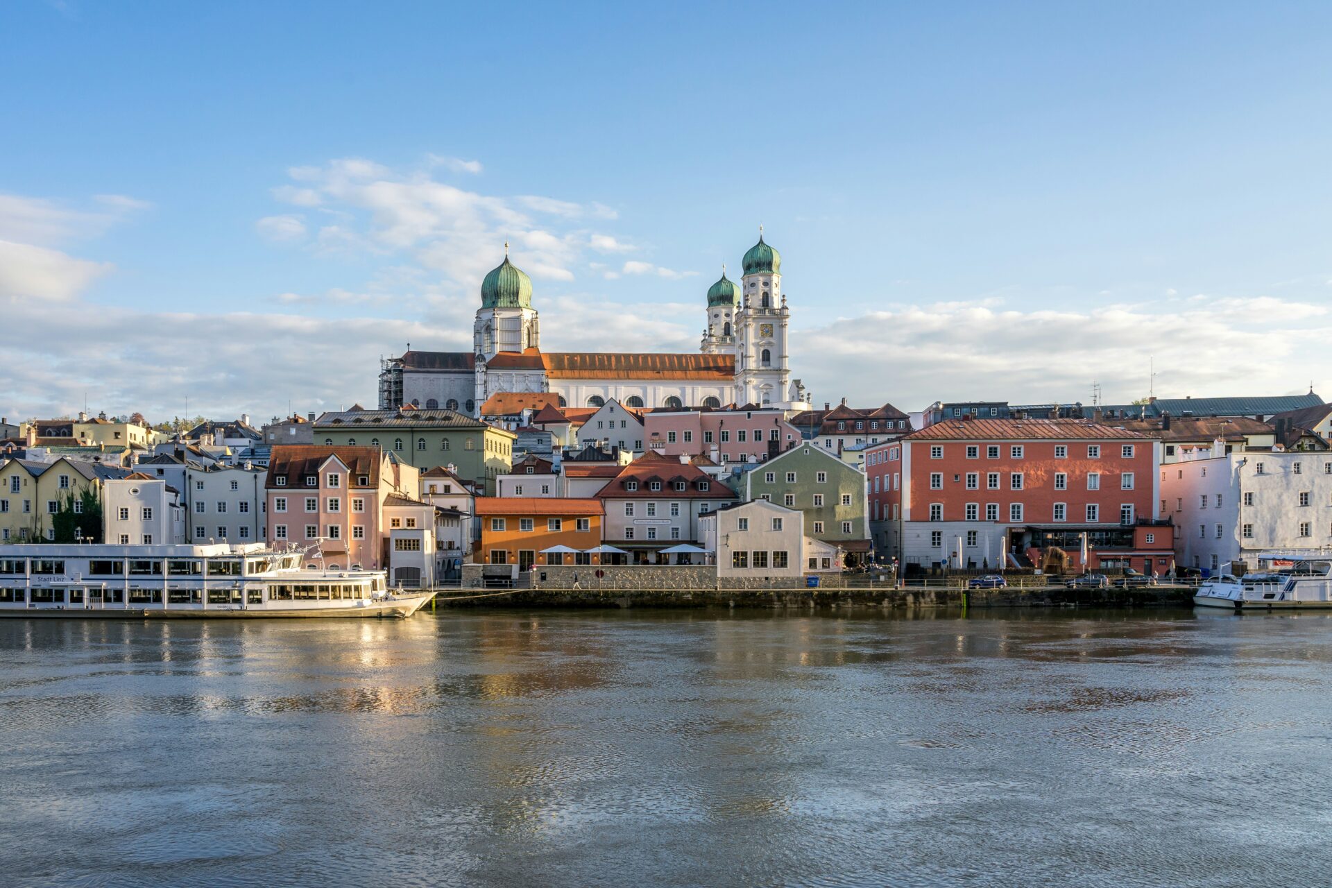 Colorful village houses lining the riverbank near Passau